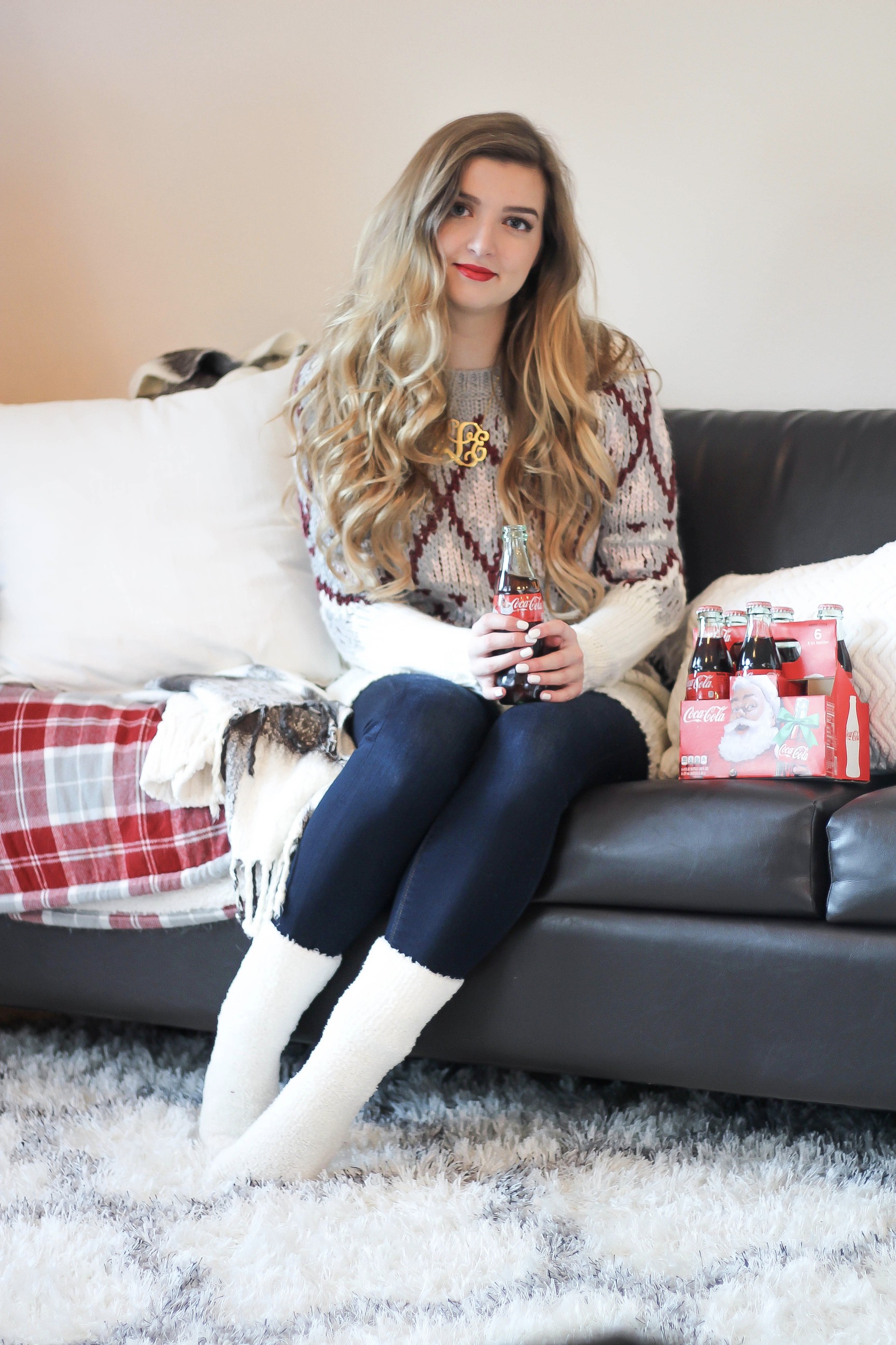 SLEIGH YOUR LOOK! Adorable oversized sweater with fun colors and pattern. Super cozy winter outfit. Pomeranian puppy, white Pomeranian, miniature Pomeranian, toy Pomeranian, red lips and curled hair by Lauren Lindmark dailydoseofcharm.com daily dose of charm