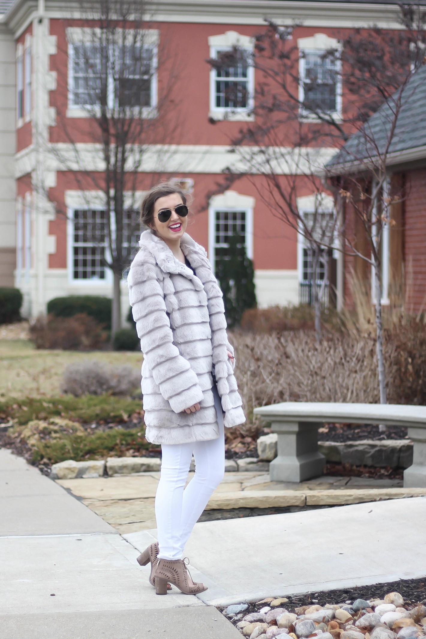 Fur coats are a closet necessity! This faux fur coat is my favorite and look adorable with white pants, cute heels, and bright pink lips! By Lauren Lindmark on dailydoseofcharm.com daily dose of charm