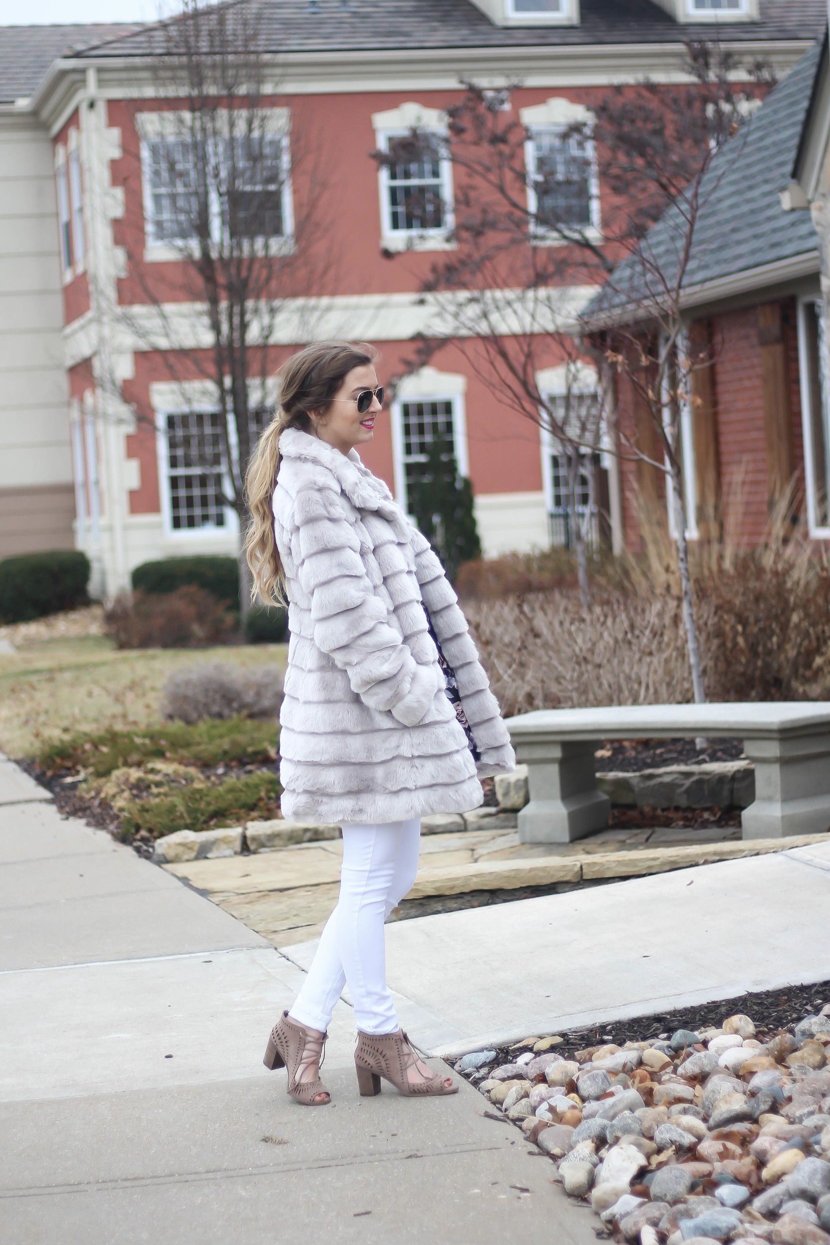 Fur coats are a closet necessity! This faux fur coat is my favorite and look adorable with white pants, cute heels, and bright pink lips! By Lauren Lindmark on dailydoseofcharm.com daily dose of charm