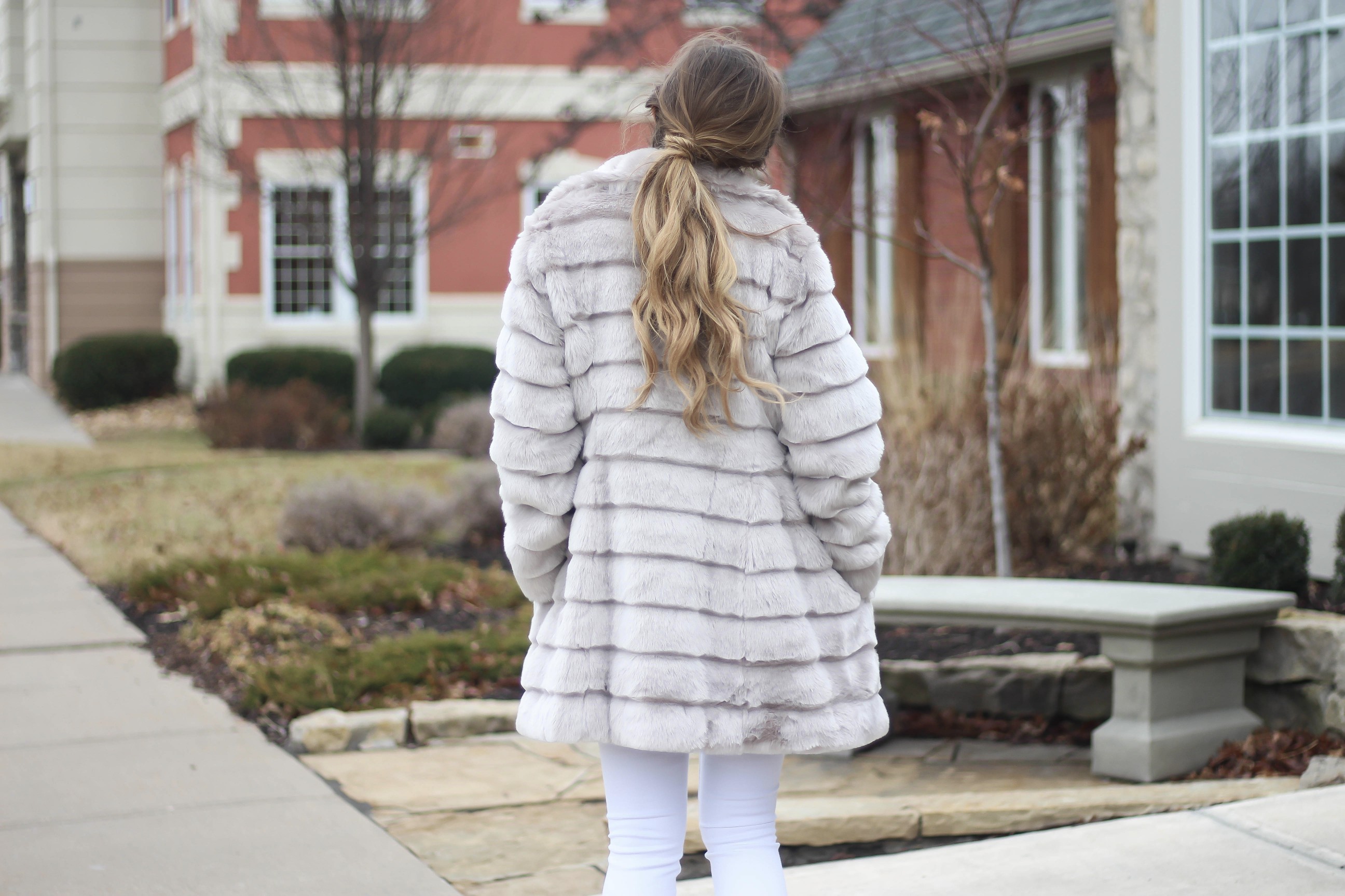 Fur coats are a closet necessity! This faux fur coat is my favorite and look adorable with white pants, cute heels, and bright pink lips! By Lauren Lindmark on dailydoseofcharm.com daily dose of charm