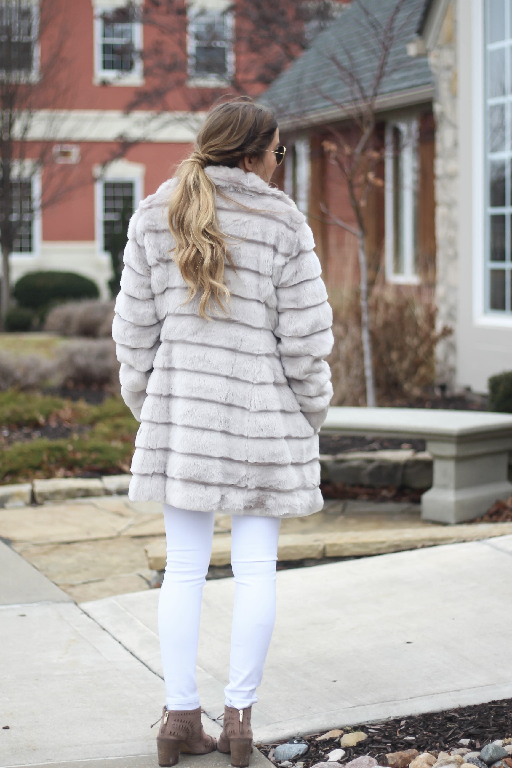 Fur coats are a closet necessity! This faux fur coat is my favorite and look adorable with white pants, cute heels, and bright pink lips! By Lauren Lindmark on dailydoseofcharm.com daily dose of charm