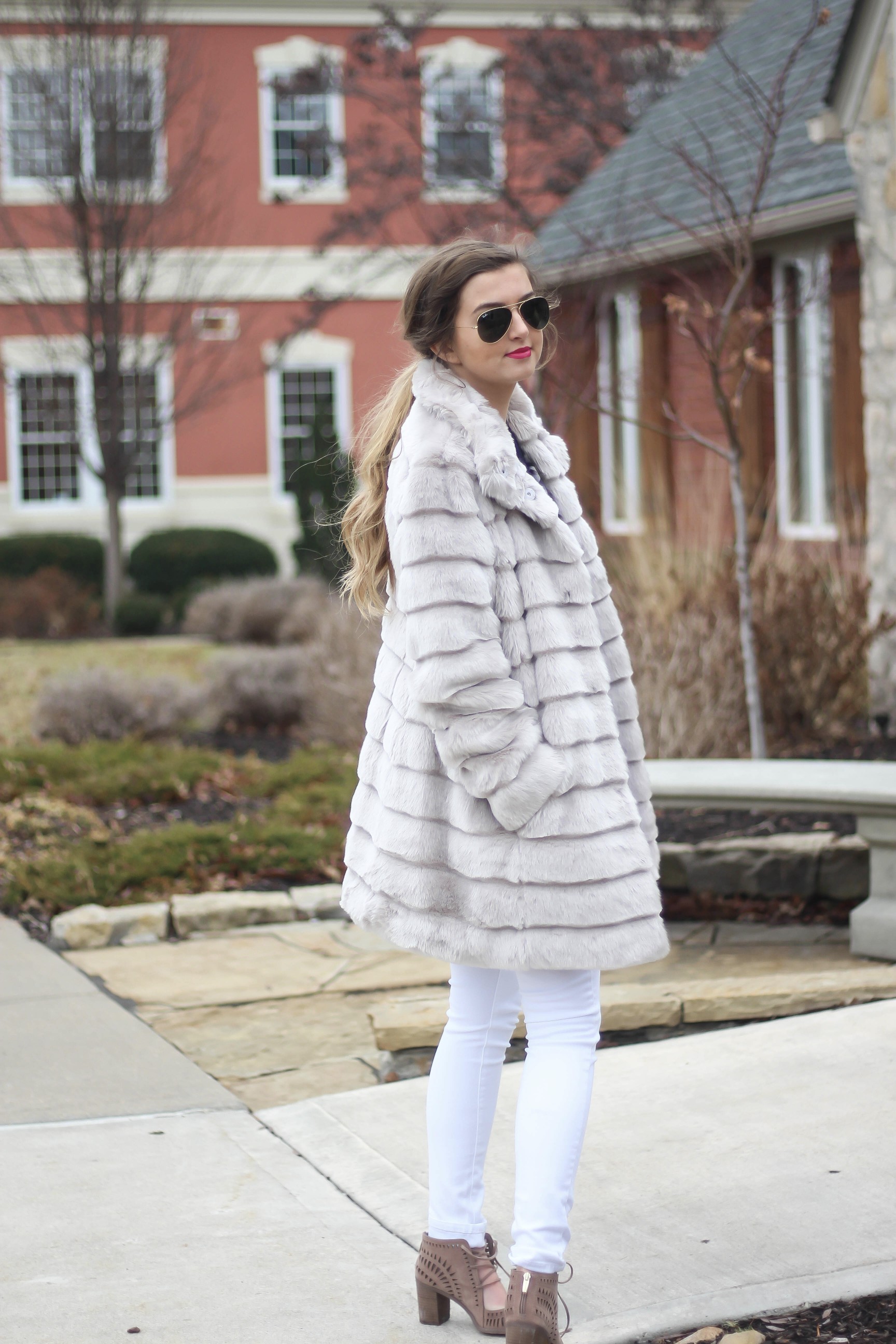 Fur coats are a closet necessity! This faux fur coat is my favorite and look adorable with white pants, cute heels, and bright pink lips! By Lauren Lindmark on dailydoseofcharm.com daily dose of charm