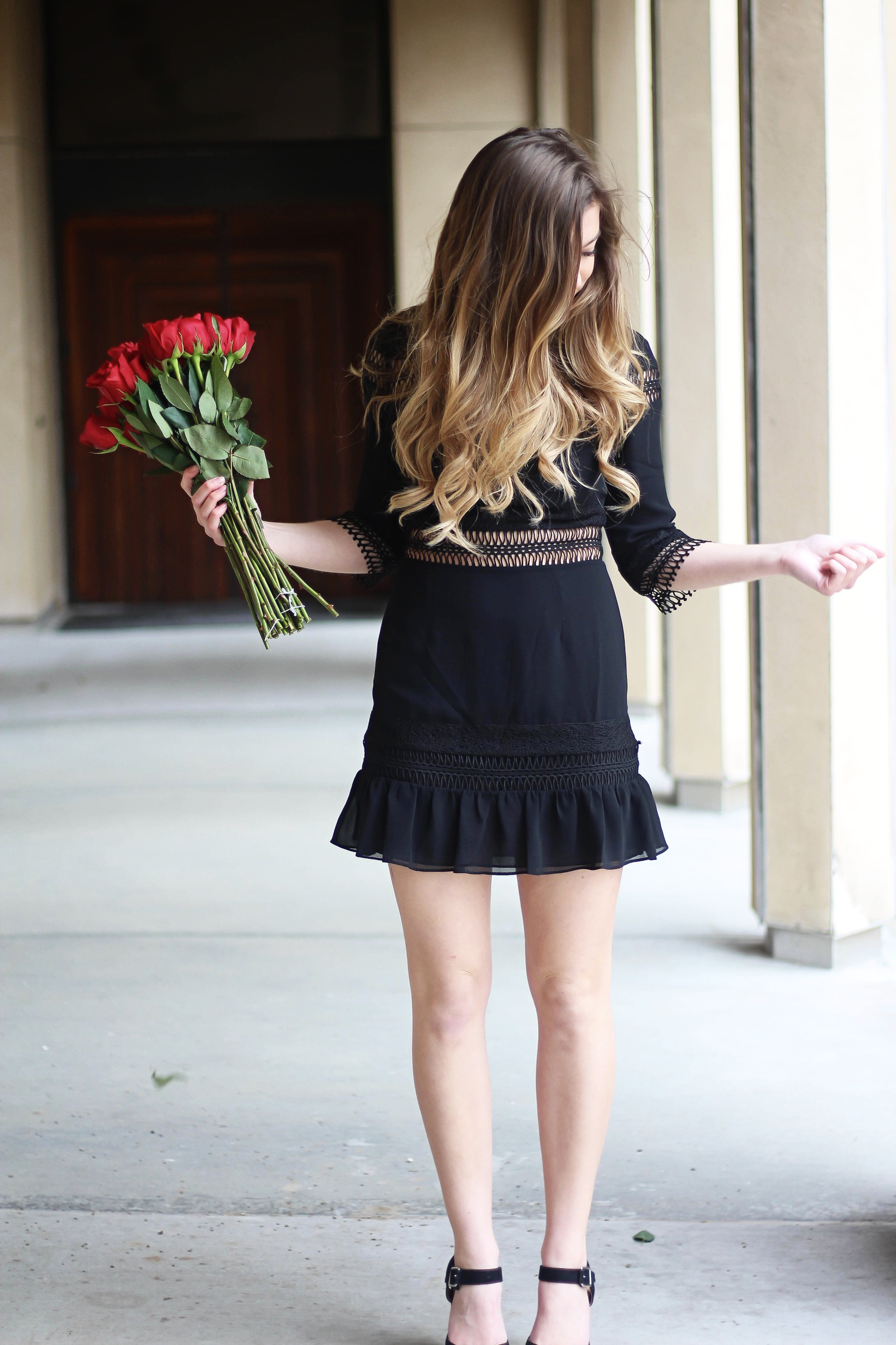 Valentines Day outfit! This little black dress is so perfect for any special occasion. I love the lace details around the waste and on the sleeves! I paired it with some chunky black heels, cluster earrings, and red lips! Plus of course some roses! By Lauren Lindmark on daily dose of charm dailydoseofcharm.com