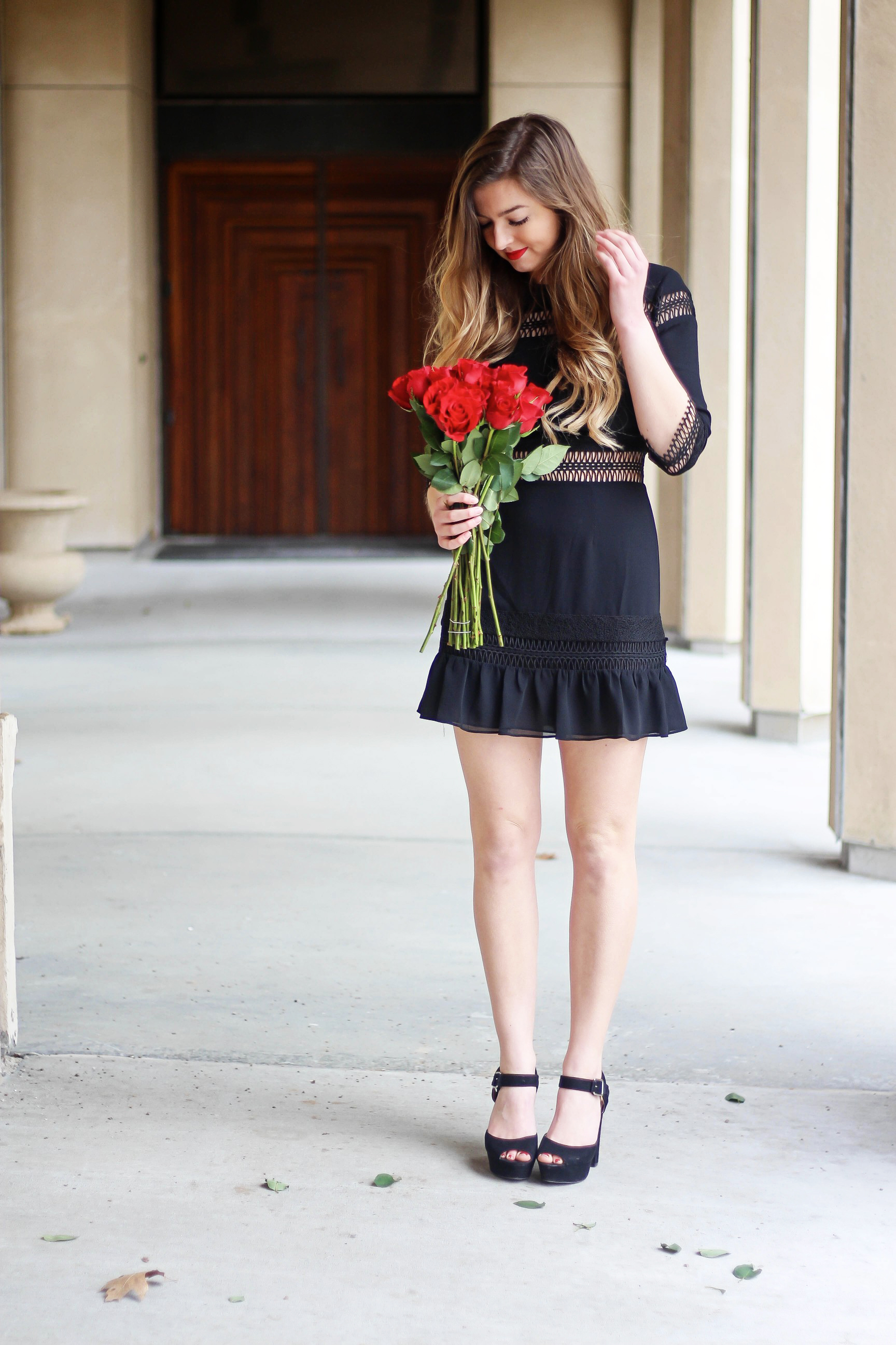 Valentines Day outfit! This little black dress is so perfect for any special occasion. I love the lace details around the waste and on the sleeves! I paired it with some chunky black heels, cluster earrings, and red lips! Plus of course some roses! By Lauren Lindmark on daily dose of charm dailydoseofcharm.com