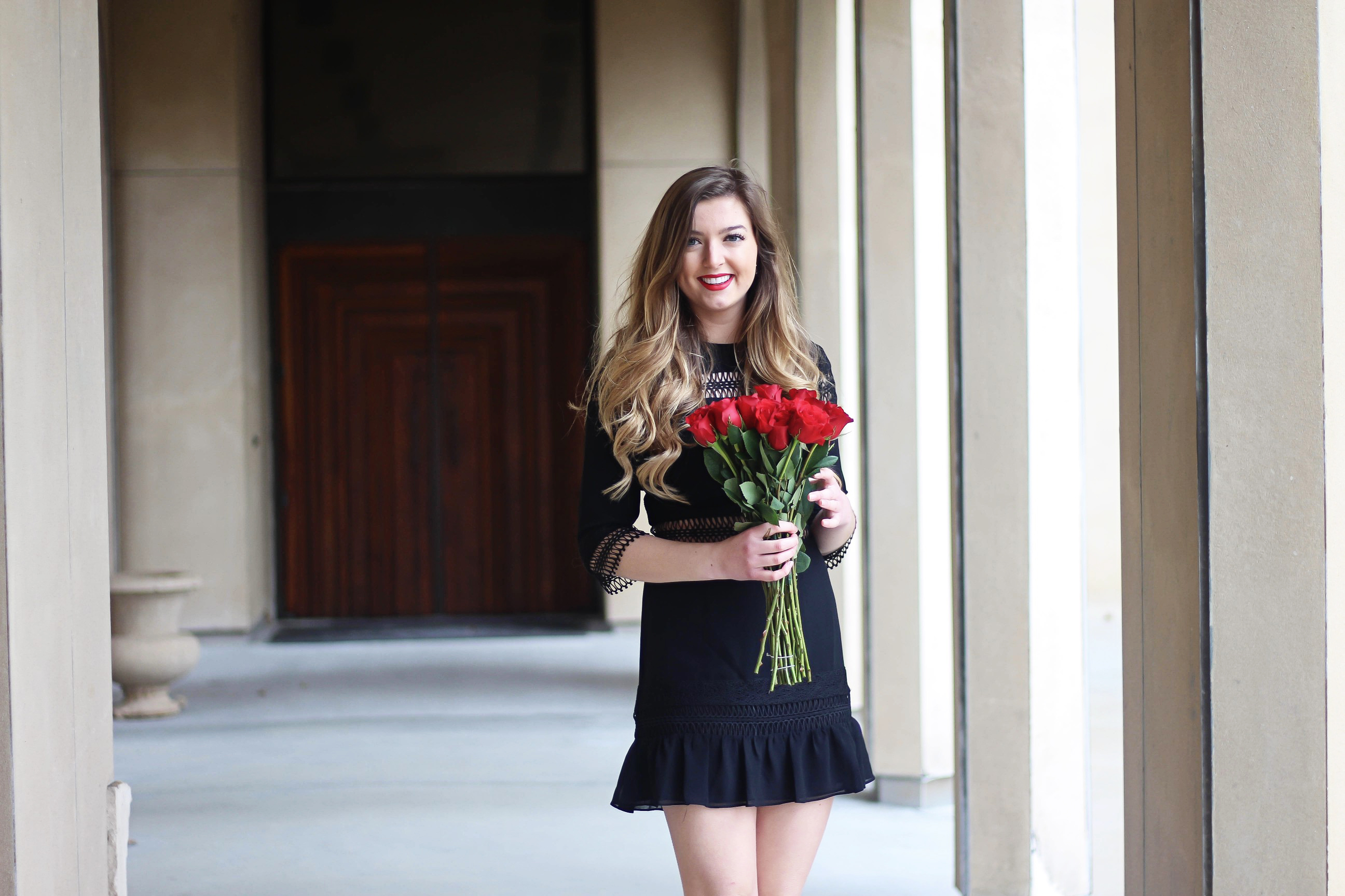 Valentines Day outfit! This little black dress is so perfect for any special occasion. I love the lace details around the waste and on the sleeves! I paired it with some chunky black heels, cluster earrings, and red lips! Plus of course some roses! By Lauren Lindmark on daily dose of charm dailydoseofcharm.com