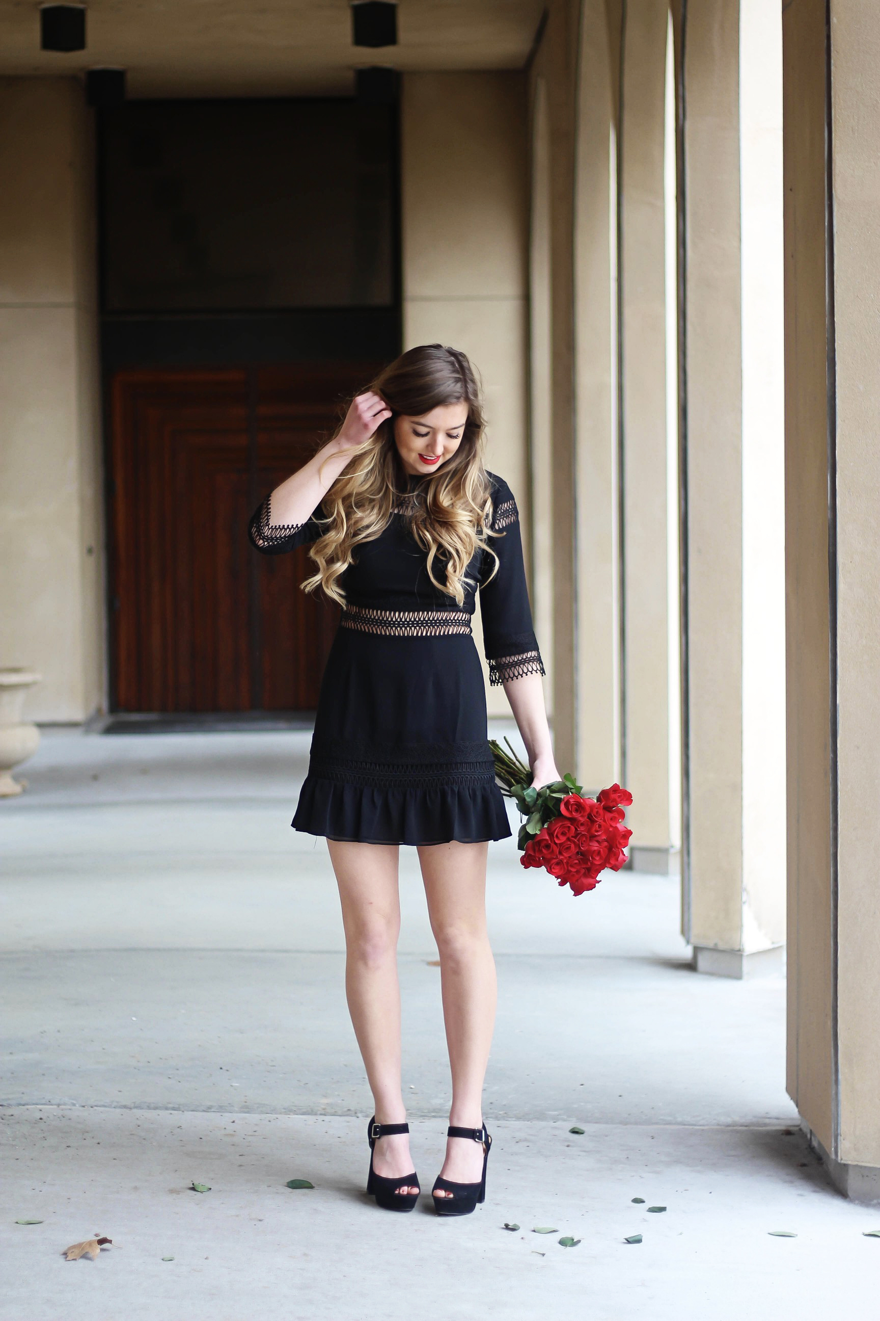 Valentines Day outfit! This little black dress is so perfect for any special occasion. I love the lace details around the waste and on the sleeves! I paired it with some chunky black heels, cluster earrings, and red lips! Plus of course some roses! By Lauren Lindmark on daily dose of charm dailydoseofcharm.com