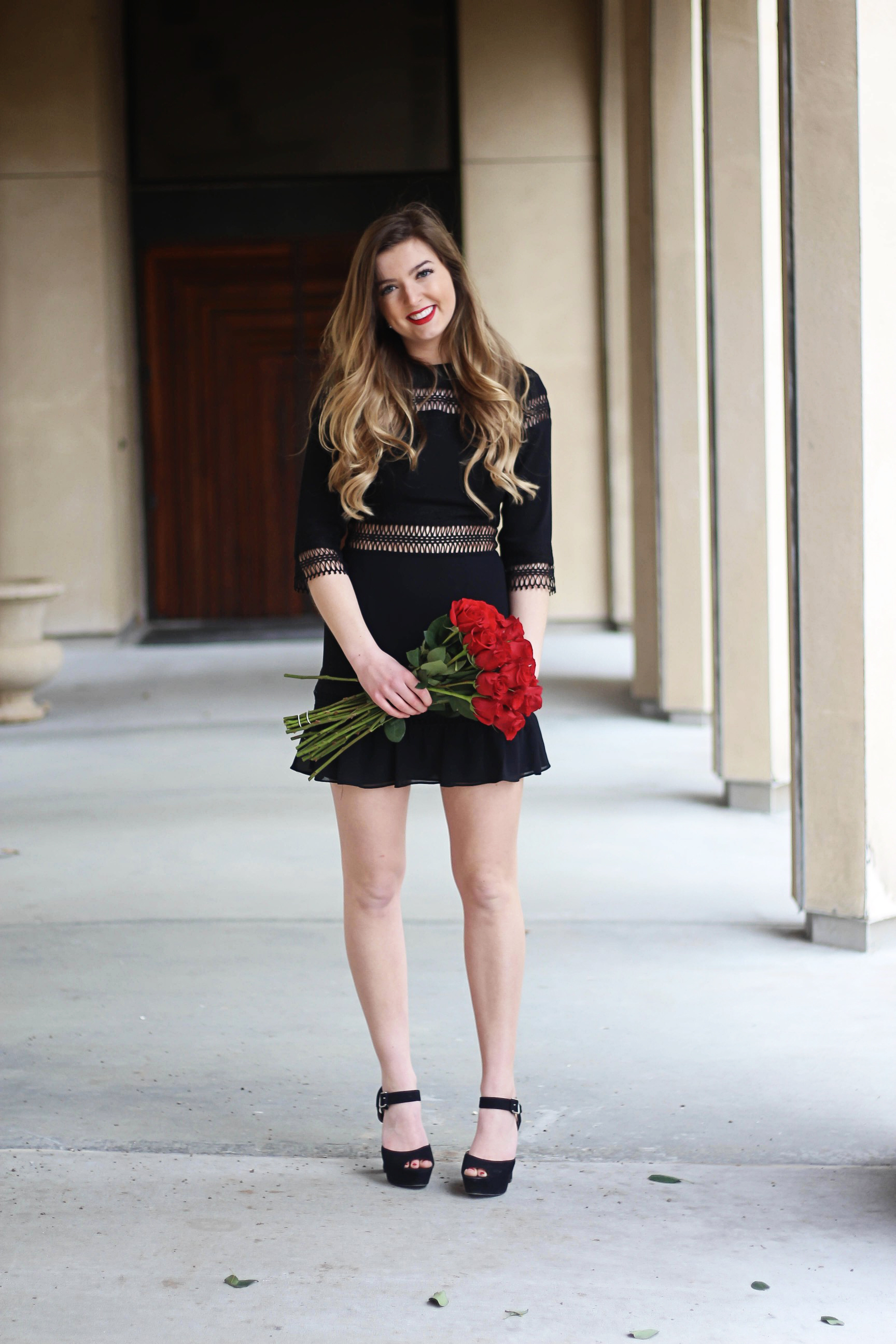 Valentines Day outfit! This little black dress is so perfect for any special occasion. I love the lace details around the waste and on the sleeves! I paired it with some chunky black heels, cluster earrings, and red lips! Plus of course some roses! By Lauren Lindmark on daily dose of charm dailydoseofcharm.com