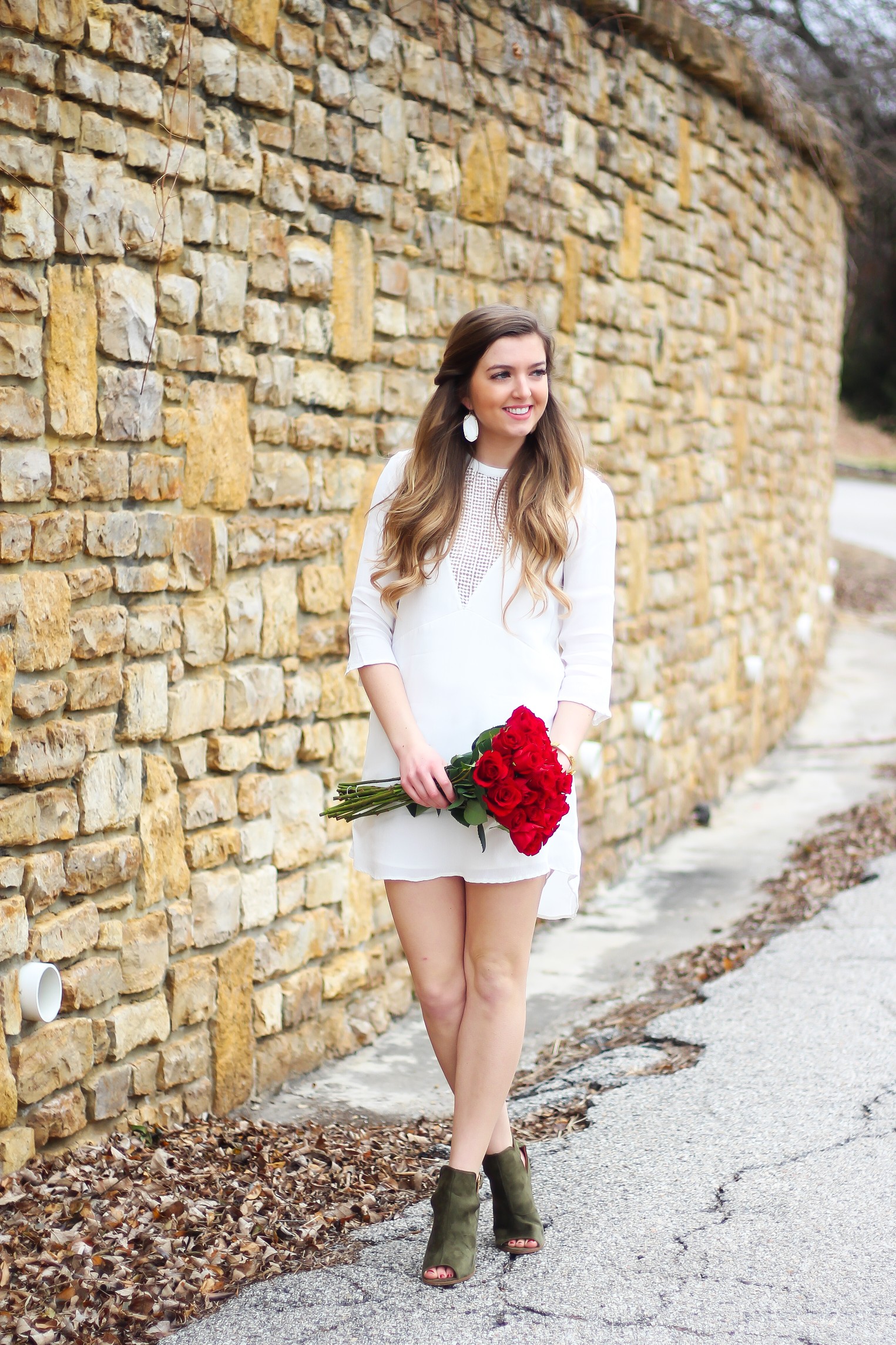 Perfect Valentine's Day look! If you need to know what to wear for Valentines Day look no further! Love this white deep vneck lace dress, especially with hunter green booties! I paired it with white Kendra Scott earrings and my ray ban aviators! By Lauren Lindmark daily dose of charm on dailydoseofcharm.com 