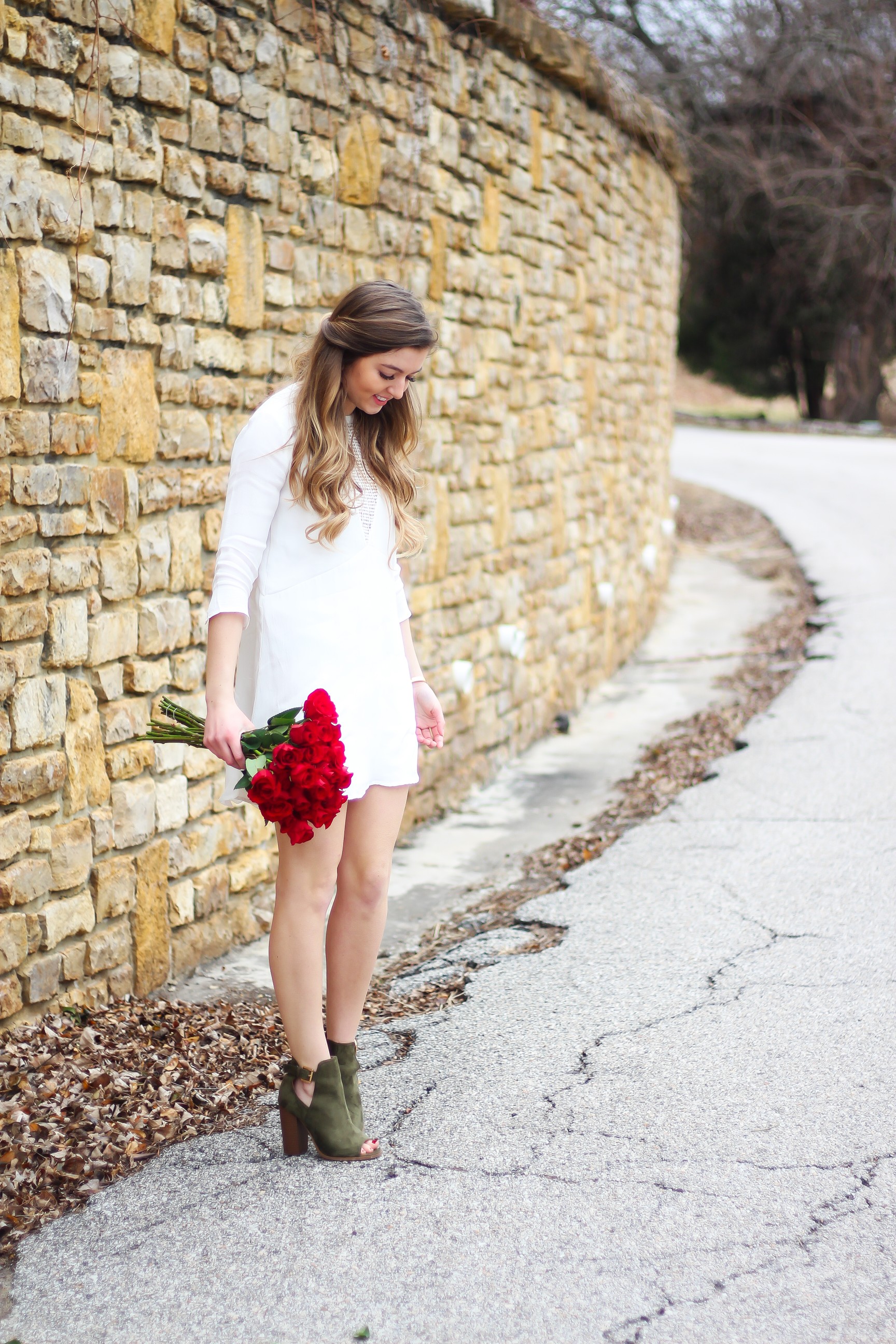 Perfect Valentine's Day look! If you need to know what to wear for Valentines Day look no further! Love this white deep vneck lace dress, especially with hunter green booties! I paired it with white Kendra Scott earrings and my ray ban aviators! By Lauren Lindmark daily dose of charm on dailydoseofcharm.com 