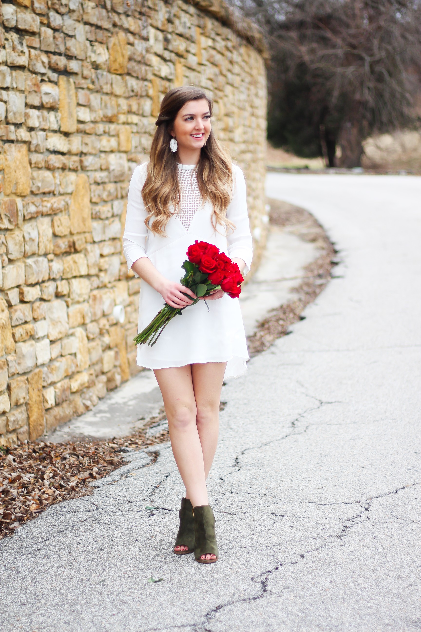 Perfect Valentine's Day look! If you need to know what to wear for Valentines Day look no further! Love this white deep vneck lace dress, especially with hunter green booties! I paired it with white Kendra Scott earrings and my ray ban aviators! By Lauren Lindmark daily dose of charm on dailydoseofcharm.com 