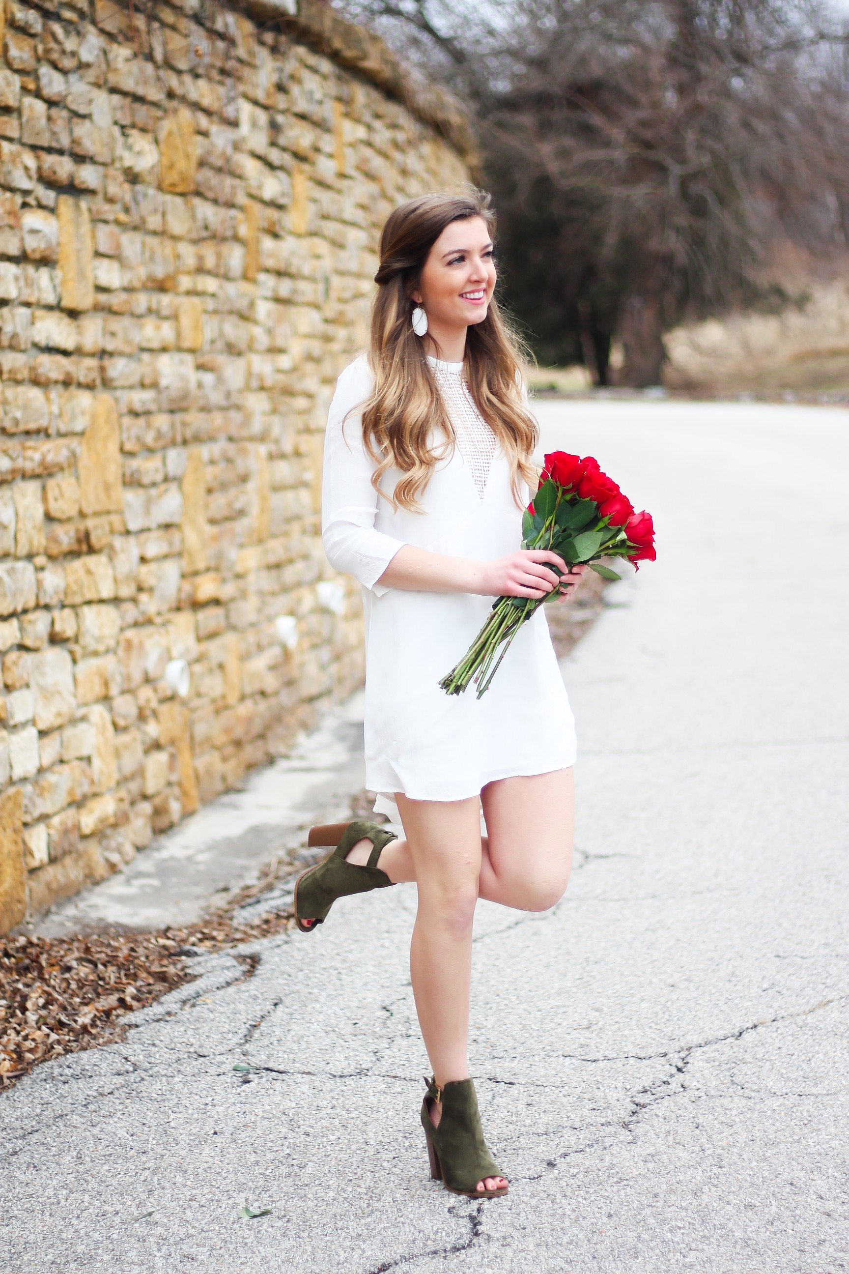 Perfect Valentine's Day look! If you need to know what to wear for Valentines Day look no further! Love this white deep vneck lace dress, especially with hunter green booties! I paired it with white Kendra Scott earrings and my ray ban aviators! By Lauren Lindmark daily dose of charm on dailydoseofcharm.com 
