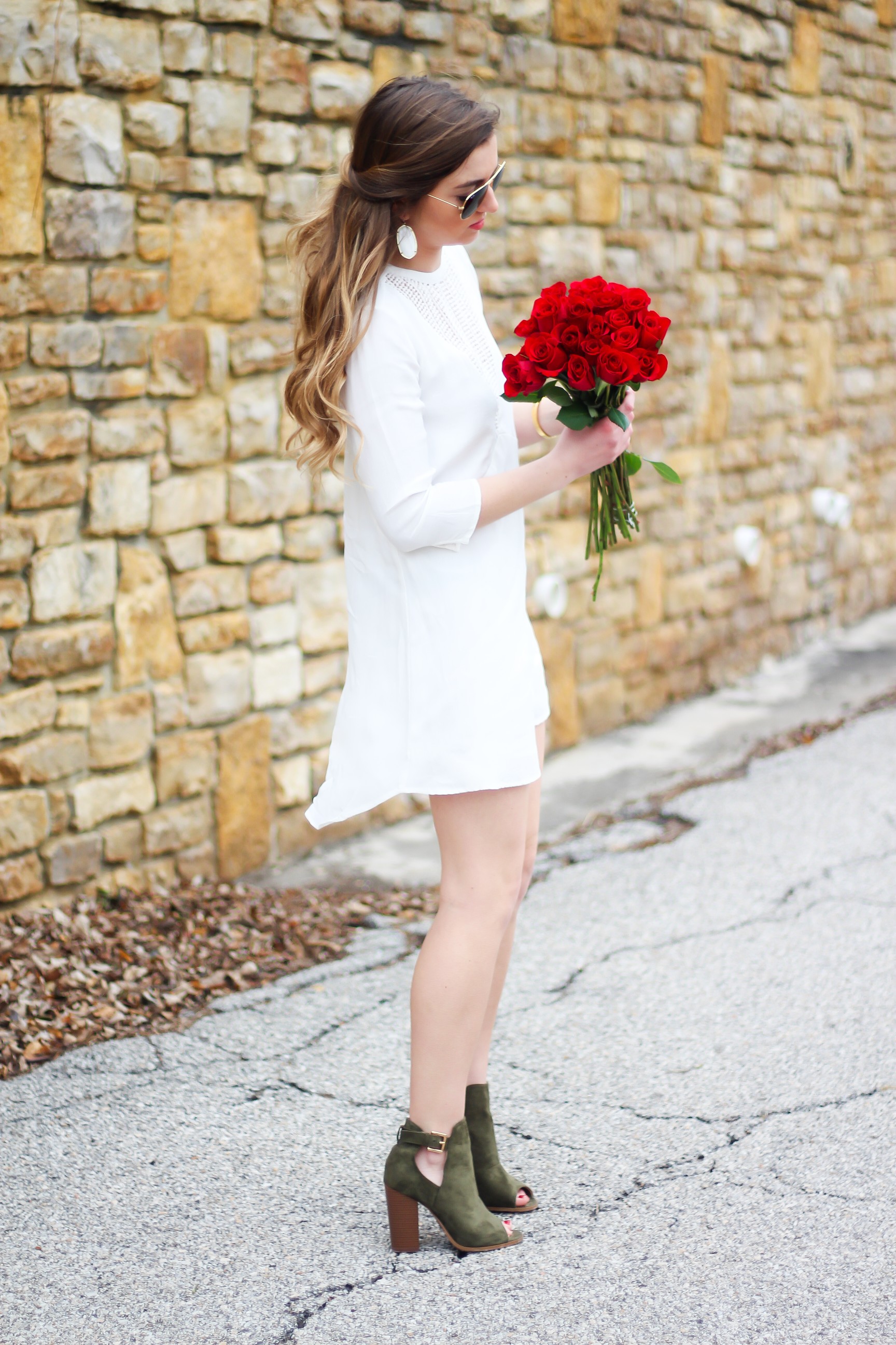 Perfect Valentine's Day look! If you need to know what to wear for Valentines Day look no further! Love this white deep vneck lace dress, especially with hunter green booties! I paired it with white Kendra Scott earrings and my ray ban aviators! By Lauren Lindmark daily dose of charm on dailydoseofcharm.com 