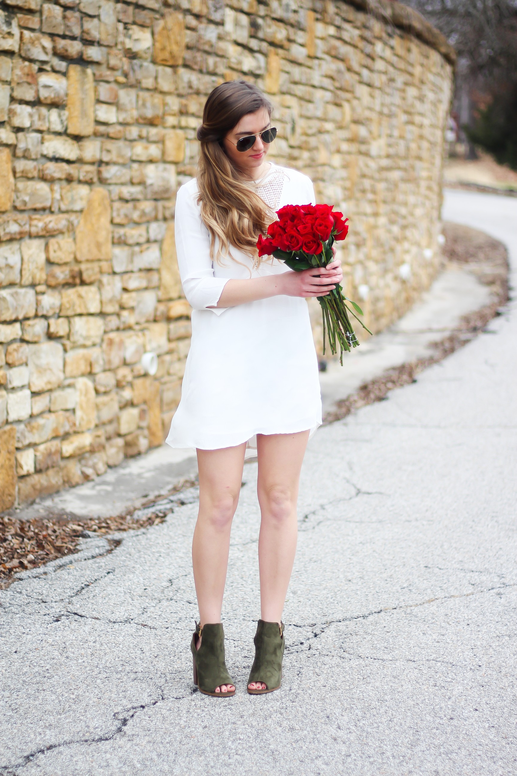 Perfect Valentine's Day look! If you need to know what to wear for Valentines Day look no further! Love this white deep vneck lace dress, especially with hunter green booties! I paired it with white Kendra Scott earrings and my ray ban aviators! By Lauren Lindmark daily dose of charm on dailydoseofcharm.com 