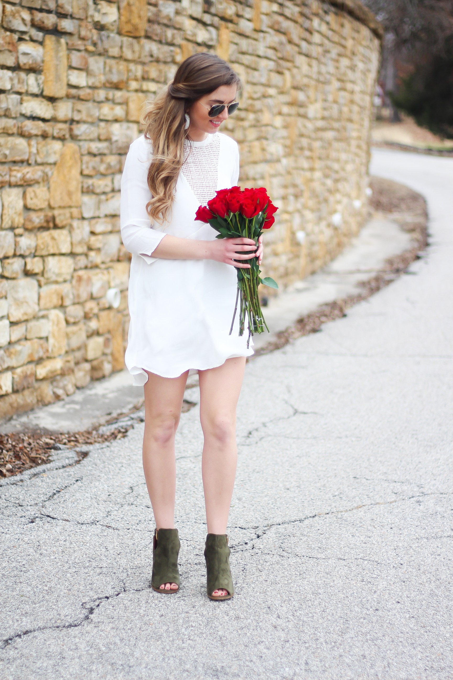 Perfect Valentine's Day look! If you need to know what to wear for Valentines Day look no further! Love this white deep vneck lace dress, especially with hunter green booties! I paired it with white Kendra Scott earrings and my ray ban aviators! By Lauren Lindmark daily dose of charm on dailydoseofcharm.com 