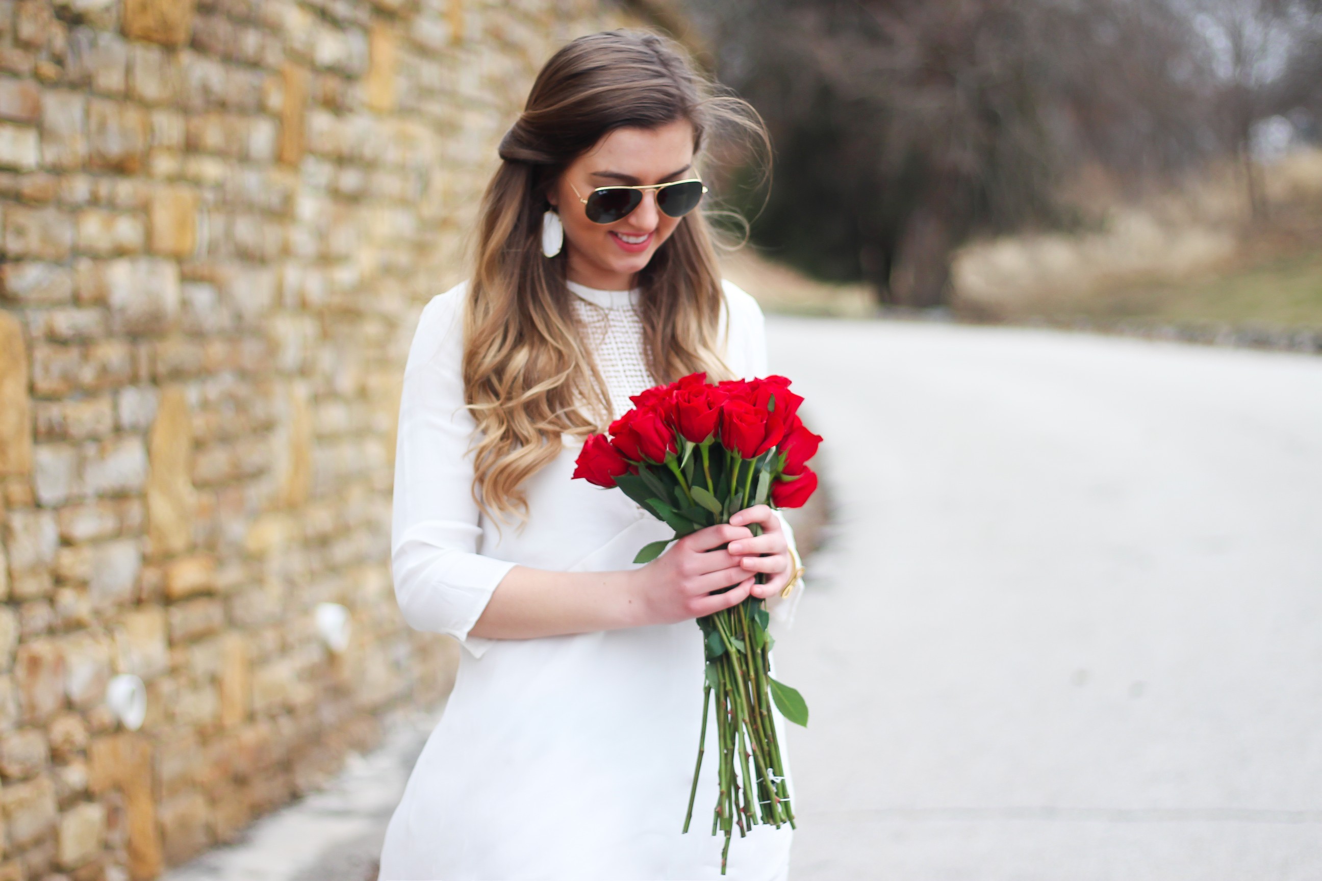 Perfect Valentine's Day look! If you need to know what to wear for Valentines Day look no further! Love this white deep vneck lace dress, especially with hunter green booties! I paired it with white Kendra Scott earrings and my ray ban aviators! By Lauren Lindmark daily dose of charm on dailydoseofcharm.com 