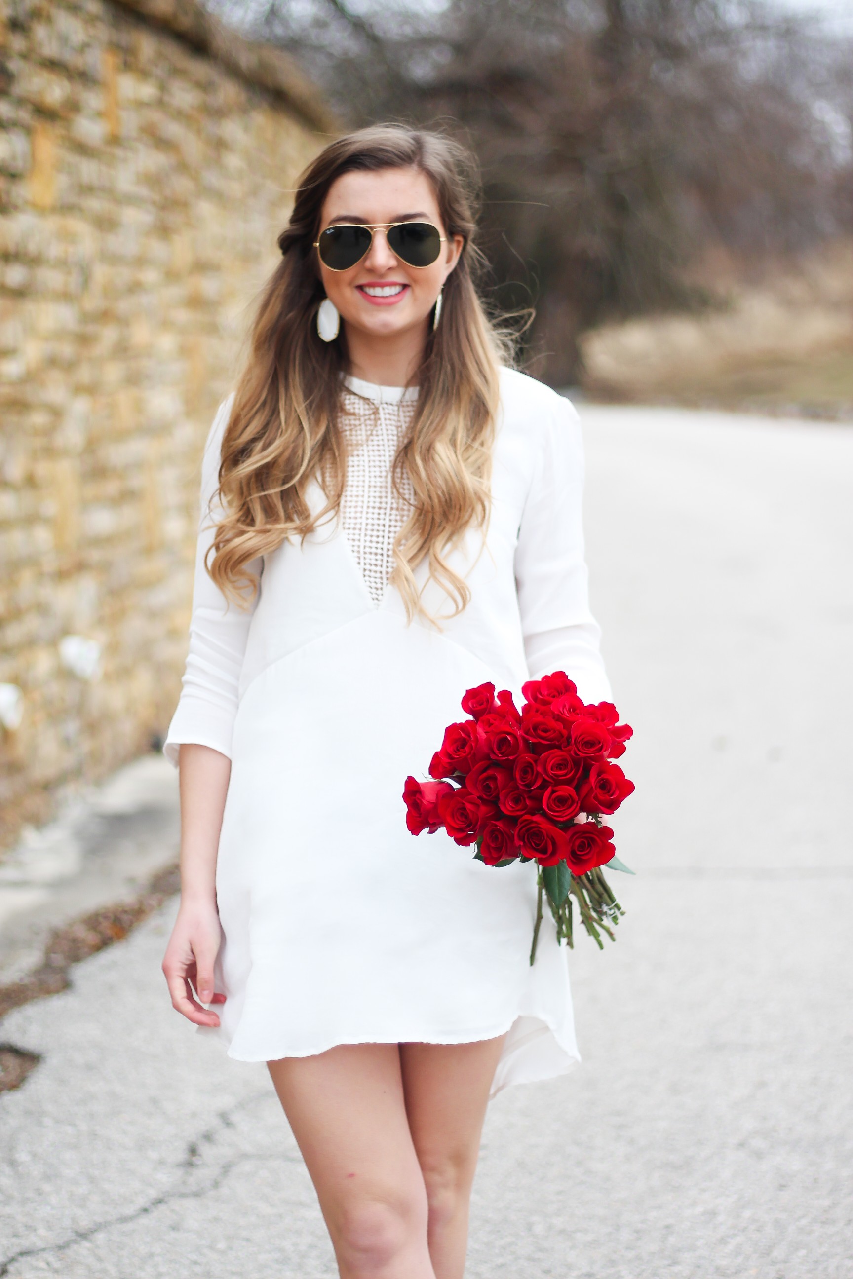 Perfect Valentine's Day look! If you need to know what to wear for Valentines Day look no further! Love this white deep vneck lace dress, especially with hunter green booties! I paired it with white Kendra Scott earrings and my ray ban aviators! By Lauren Lindmark daily dose of charm on dailydoseofcharm.com 