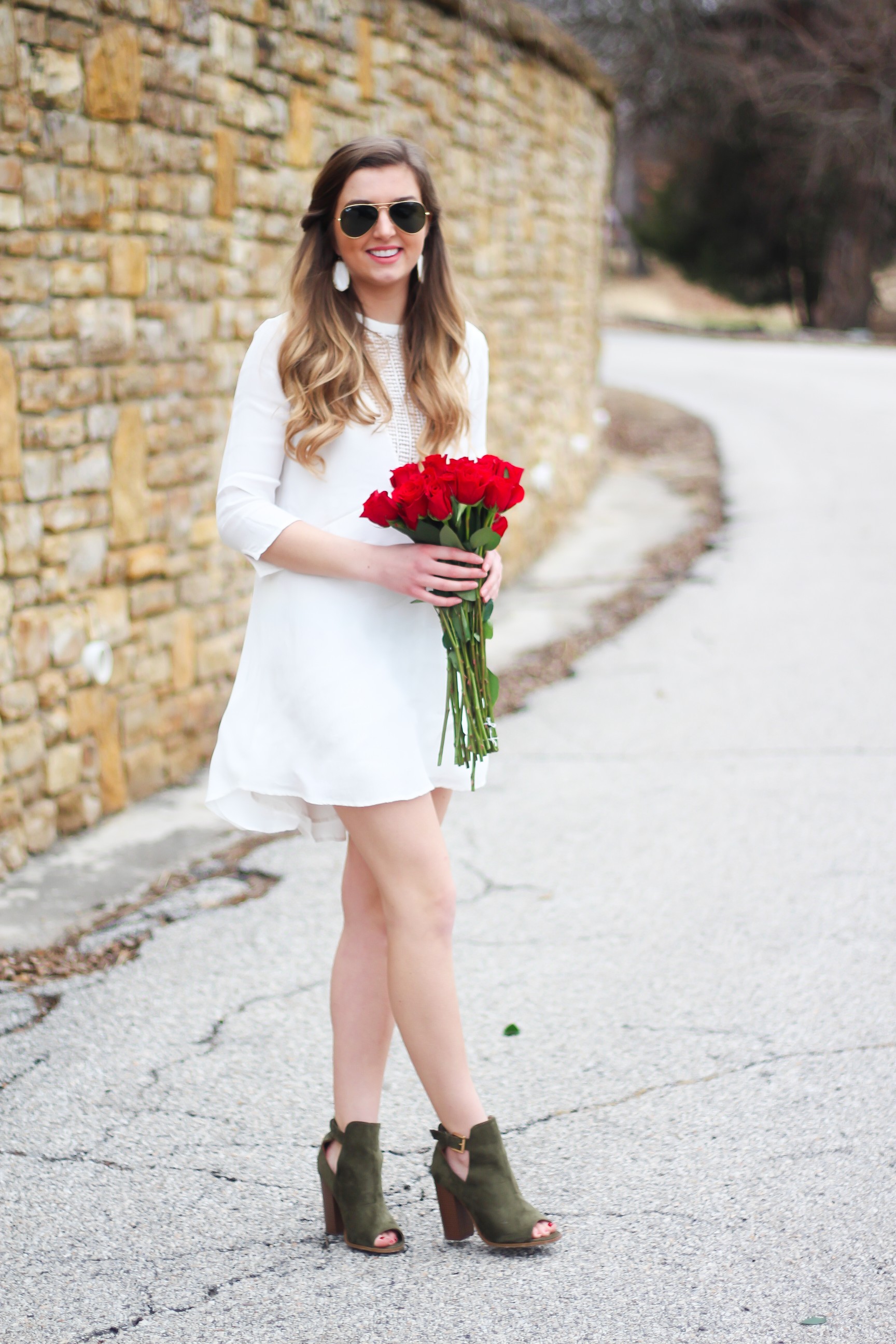 Perfect Valentine's Day look! If you need to know what to wear for Valentines Day look no further! Love this white deep vneck lace dress, especially with hunter green booties! I paired it with white Kendra Scott earrings and my ray ban aviators! By Lauren Lindmark daily dose of charm on dailydoseofcharm.com 