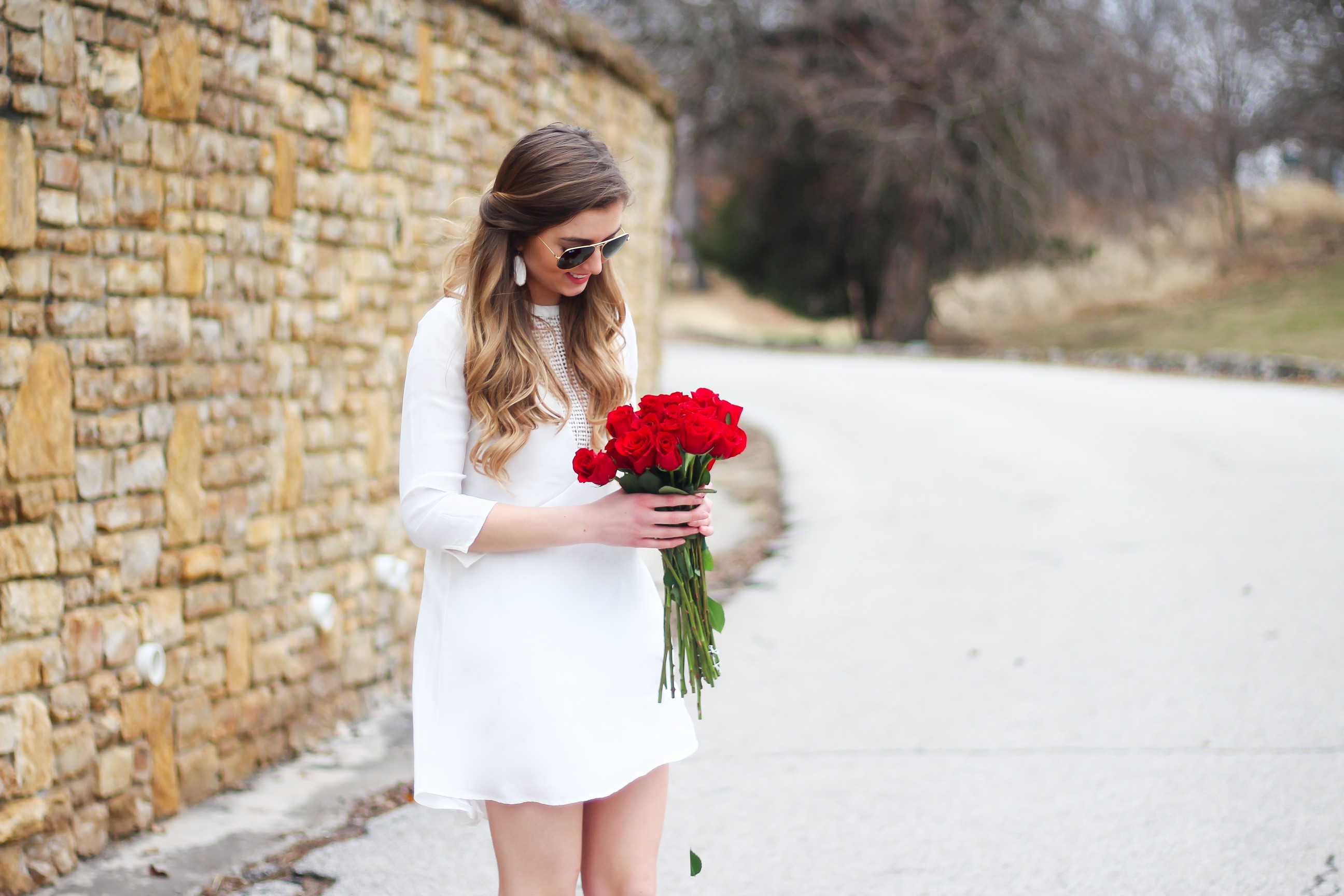 Perfect Valentine's Day look! If you need to know what to wear for Valentines Day look no further! Love this white deep vneck lace dress, especially with hunter green booties! I paired it with white Kendra Scott earrings and my ray ban aviators! By Lauren Lindmark daily dose of charm on dailydoseofcharm.com 