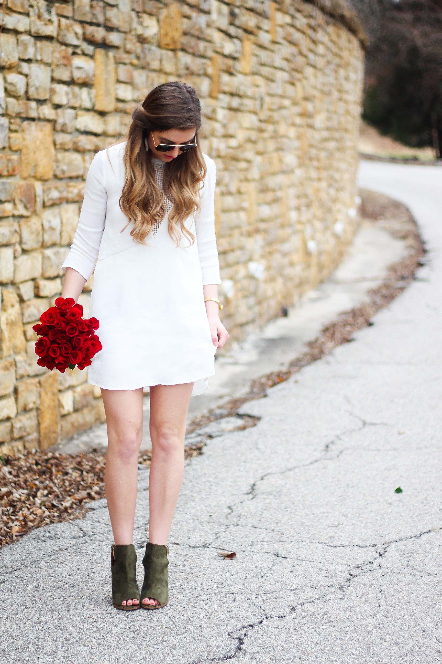 Perfect Valentine's Day look! If you need to know what to wear for Valentines Day look no further! Love this white deep vneck lace dress, especially with hunter green booties! I paired it with white Kendra Scott earrings and my ray ban aviators! By Lauren Lindmark daily dose of charm on dailydoseofcharm.com 