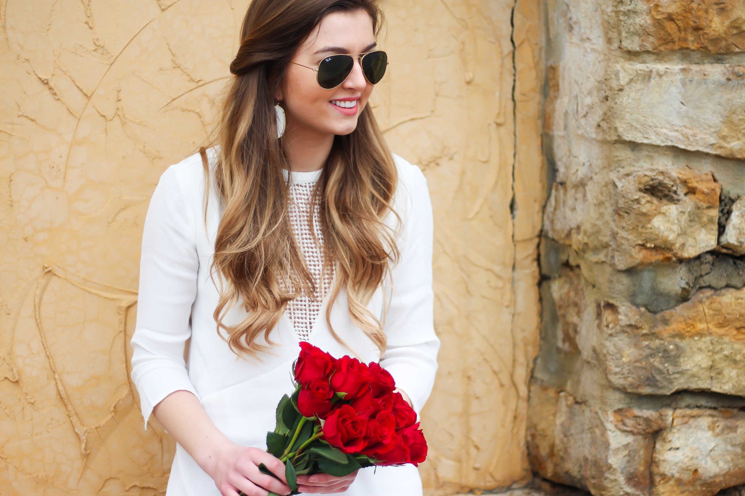 Perfect Valentine's Day look! If you need to know what to wear for Valentines Day look no further! Love this white deep vneck lace dress, especially with hunter green booties! I paired it with white Kendra Scott earrings and my ray ban aviators! By Lauren Lindmark daily dose of charm on dailydoseofcharm.com 