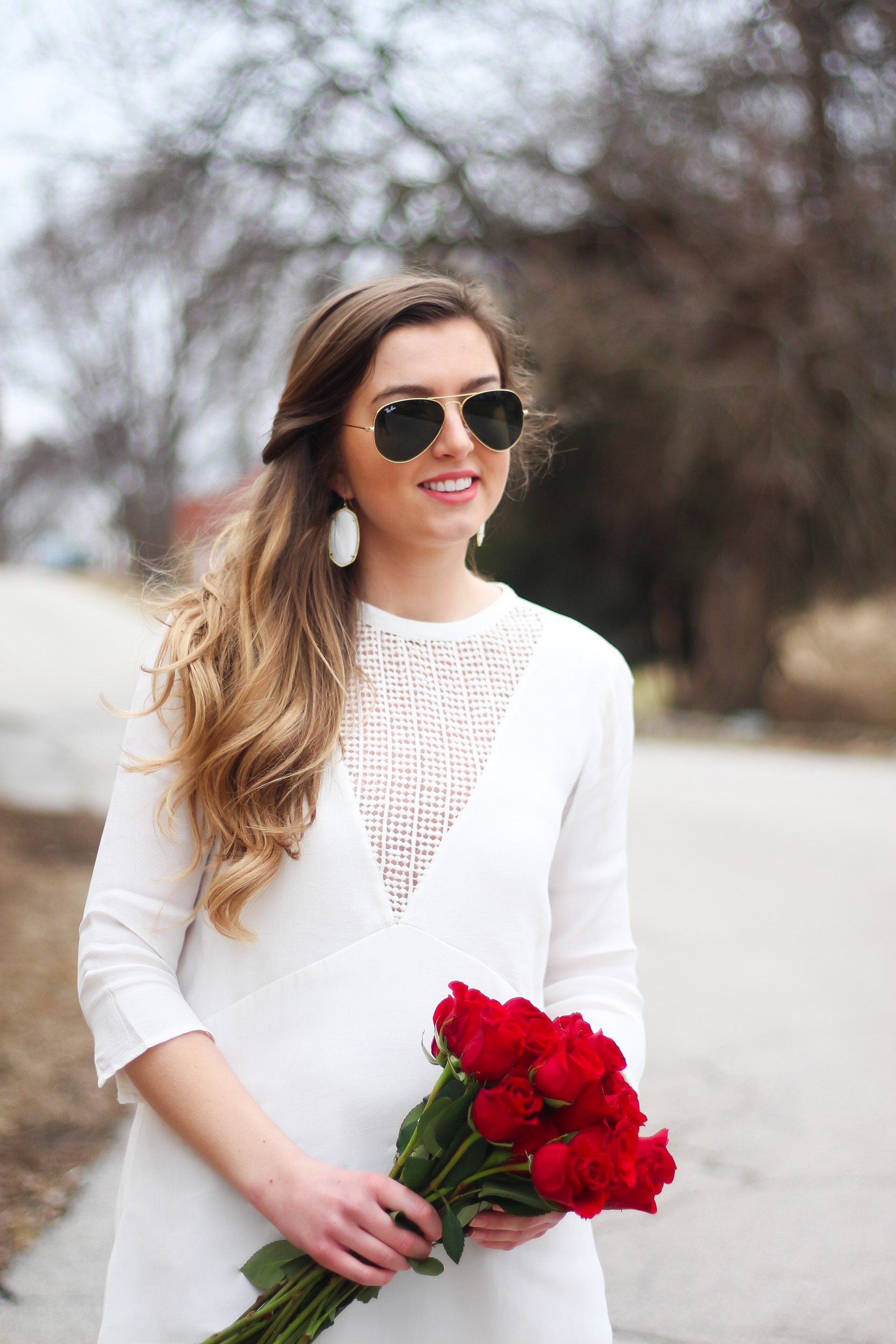 Perfect Valentine's Day look! If you need to know what to wear for Valentines Day look no further! Love this white deep vneck lace dress, especially with hunter green booties! I paired it with white Kendra Scott earrings and my ray ban aviators! By Lauren Lindmark daily dose of charm on dailydoseofcharm.com 