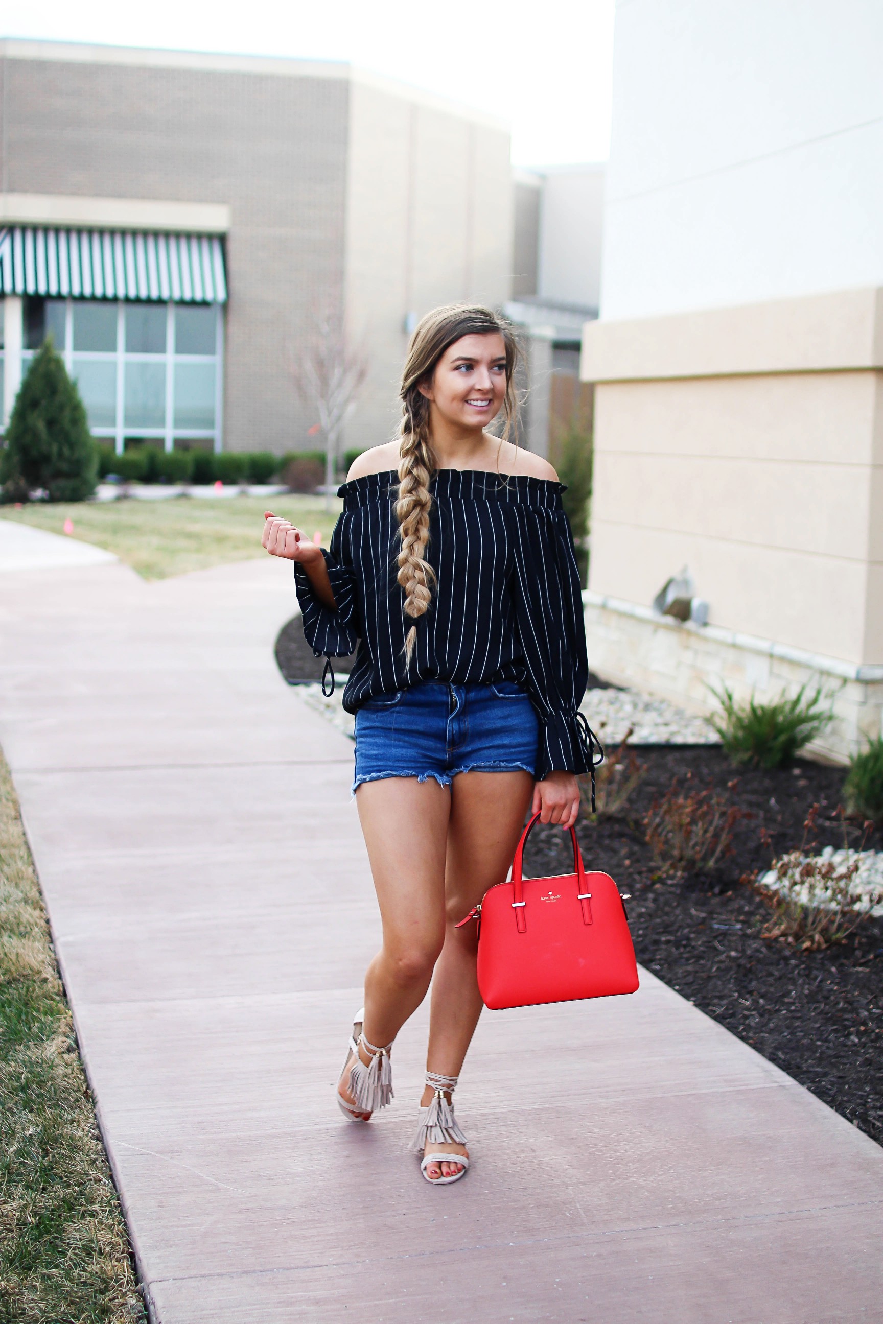 The cutest black striped off the shoulder top paired with jean shorts and a red Kate Spade purse. My favorite tassel shoes go perfectly with this look! I finished off the look with my long hair in a side braid. I love this outfit idea! By Lauren Lindmark on daily dose of charm dailydoseofcharm.com