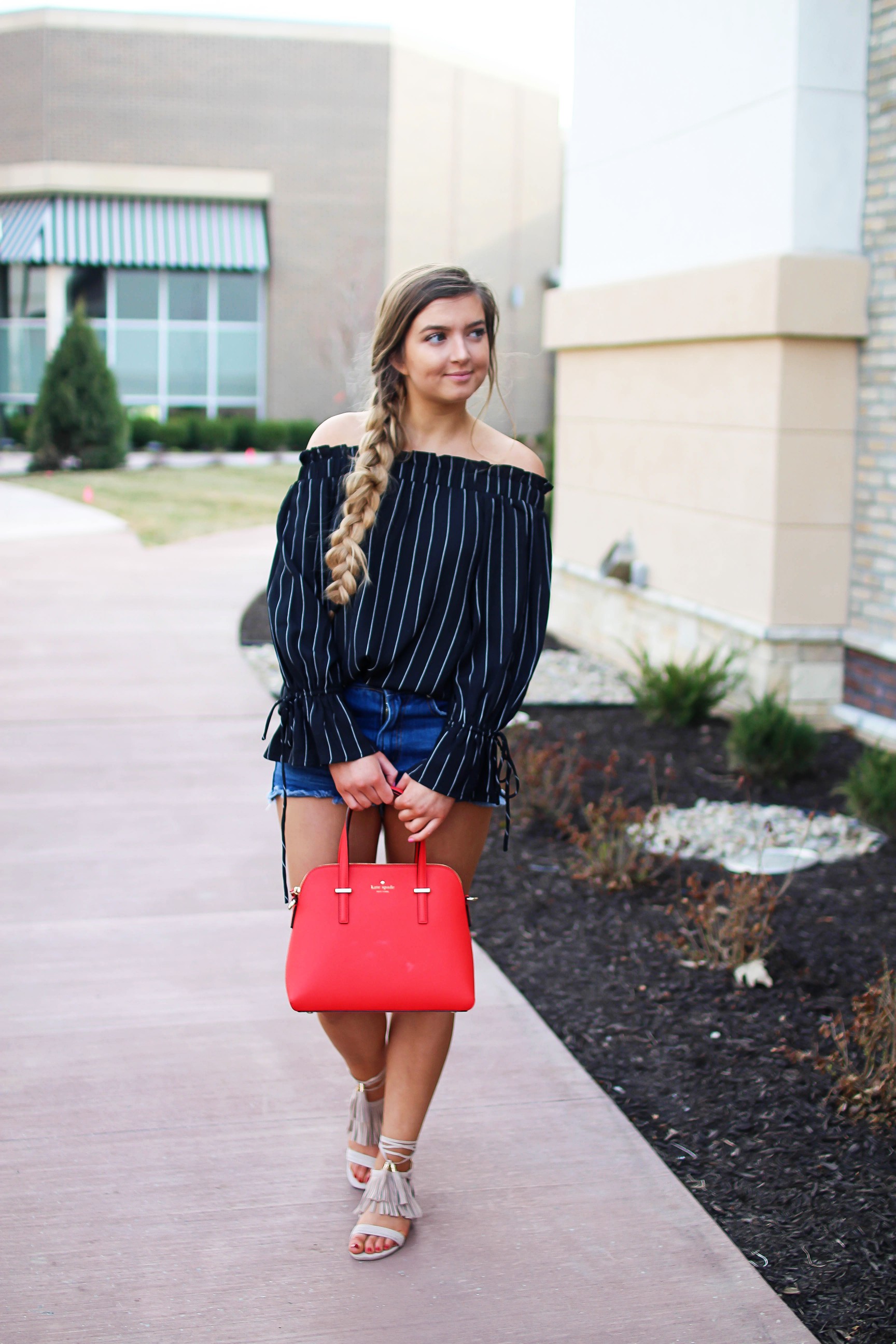 The cutest black striped off the shoulder top paired with jean shorts and a red Kate Spade purse. My favorite tassel shoes go perfectly with this look! I finished off the look with my long hair in a side braid. I love this outfit idea! By Lauren Lindmark on daily dose of charm dailydoseofcharm.com