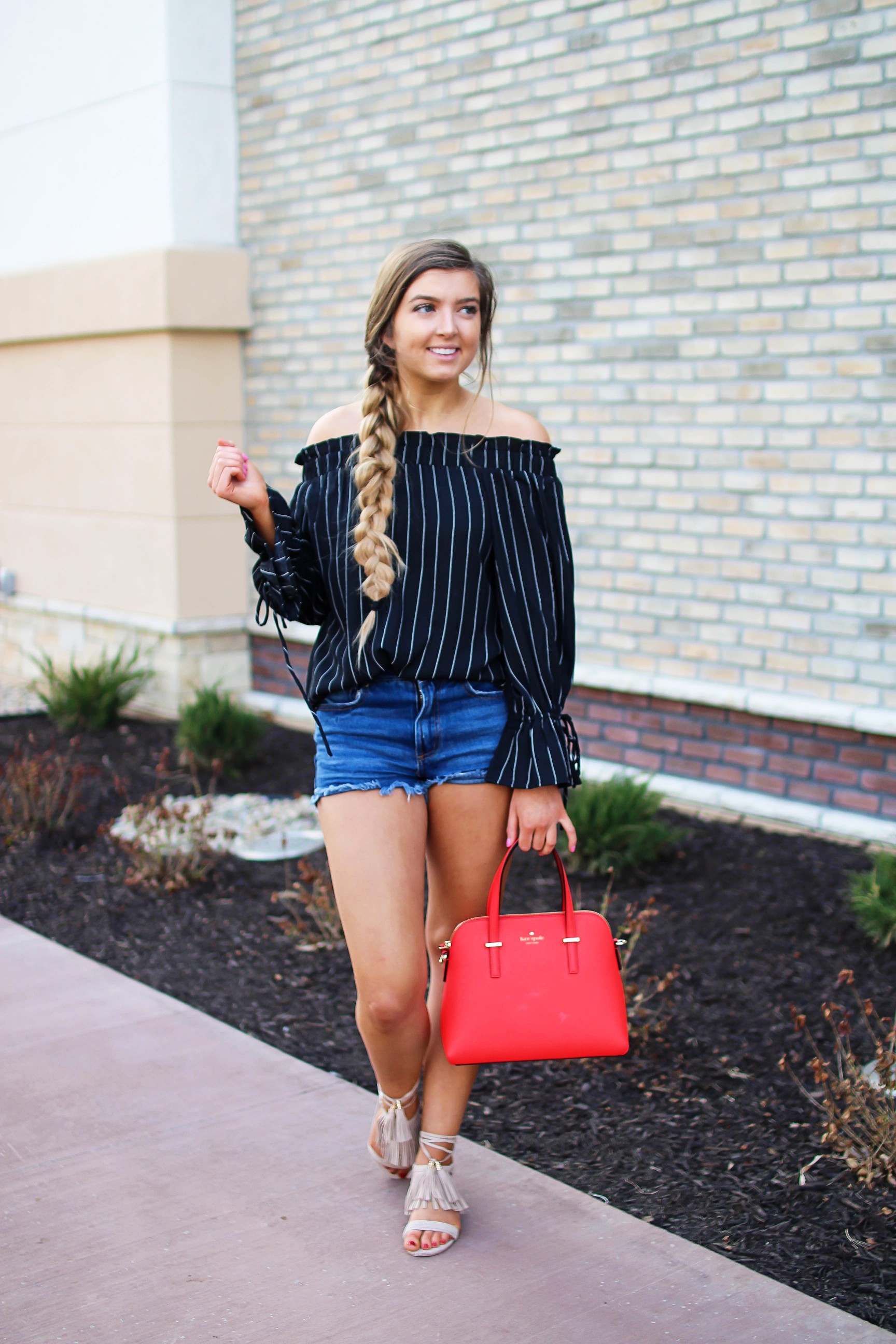The cutest black striped off the shoulder top paired with jean shorts and a red Kate Spade purse. My favorite tassel shoes go perfectly with this look! I finished off the look with my long hair in a side braid. I love this outfit idea! By Lauren Lindmark on daily dose of charm dailydoseofcharm.com