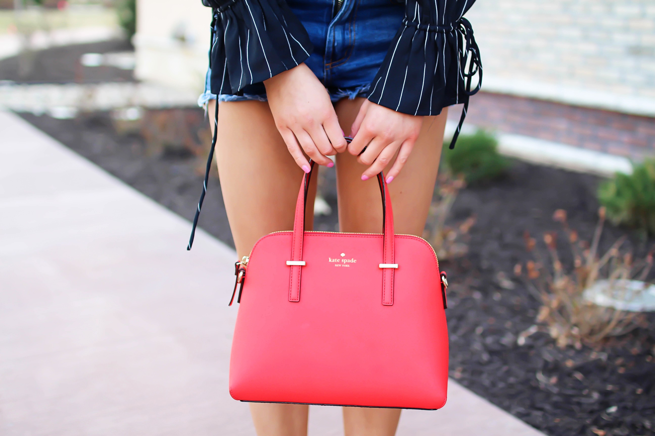 The cutest black striped off the shoulder top paired with jean shorts and a red Kate Spade purse. My favorite tassel shoes go perfectly with this look! I finished off the look with my long hair in a side braid. I love this outfit idea! By Lauren Lindmark on daily dose of charm dailydoseofcharm.com