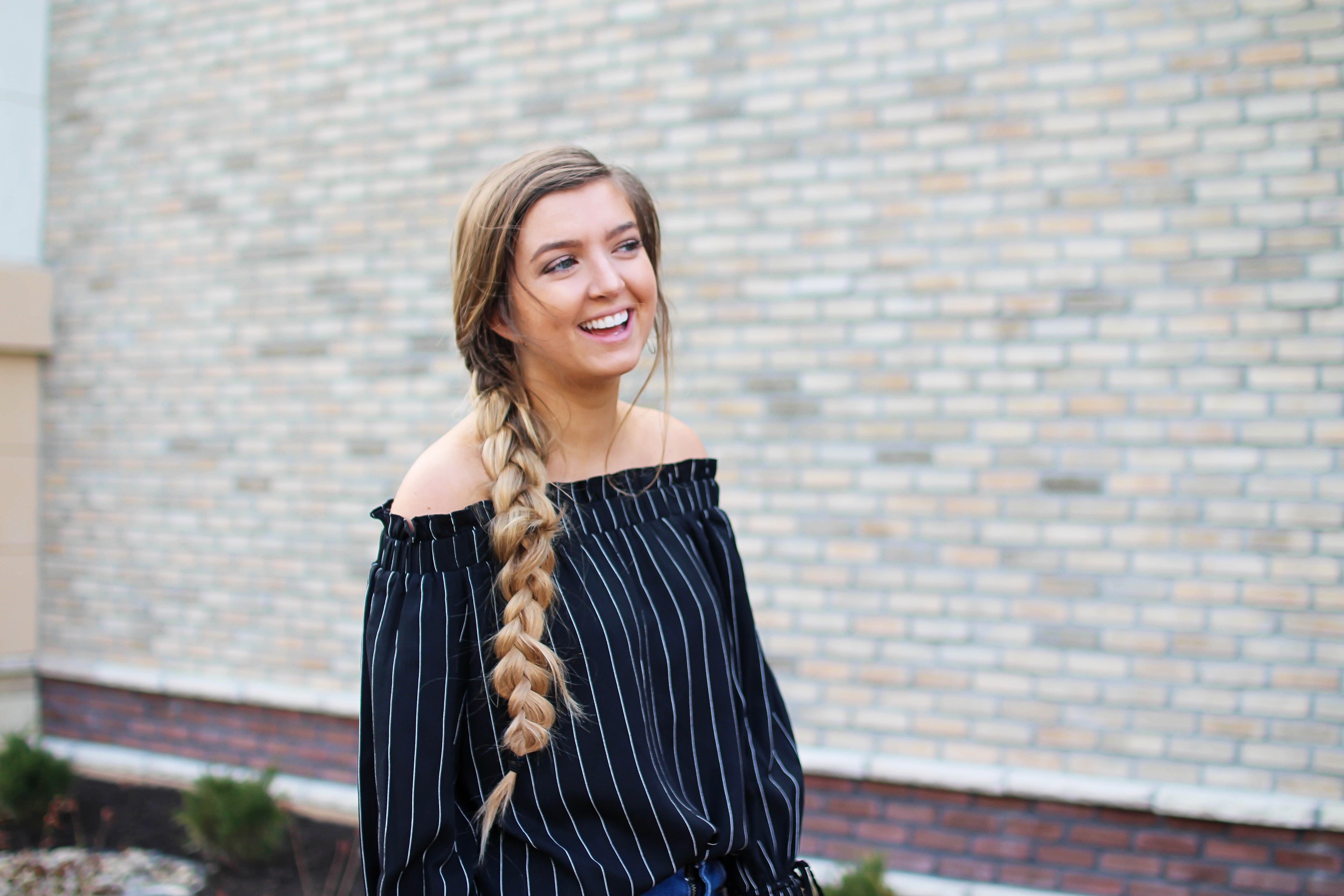 The cutest black striped off the shoulder top paired with jean shorts and a red Kate Spade purse. My favorite tassel shoes go perfectly with this look! I finished off the look with my long hair in a side braid. I love this outfit idea! By Lauren Lindmark on daily dose of charm dailydoseofcharm.com