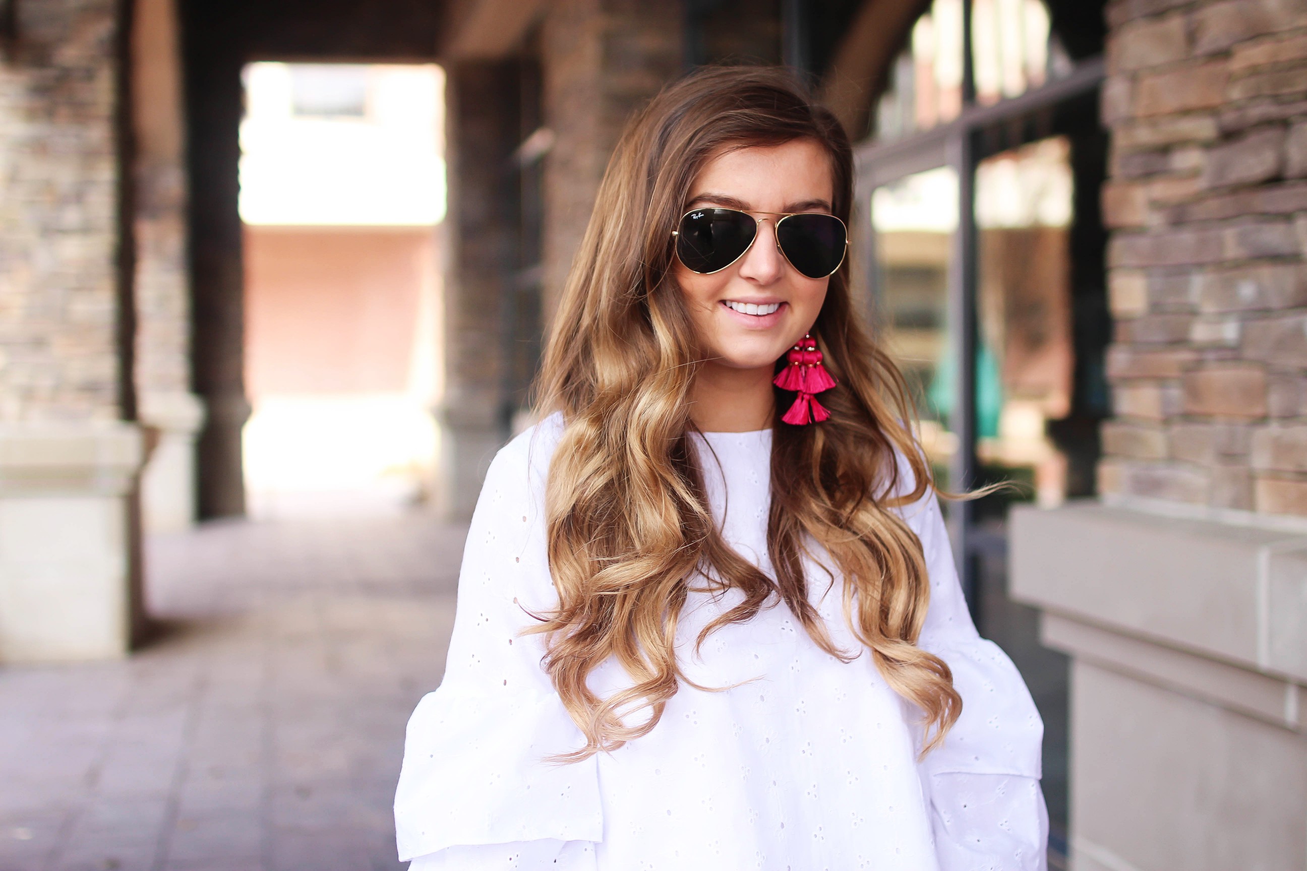 The cutest fiesta top ever! The ruffle sleeves on the top are so unique and such a cute outfit idea! I paired it with ripped jeans shorts and my tassel sandals and Kate Spade tassel earrings! By Lauren Lindmark on dailydoseofcharm.com daily dose of charm