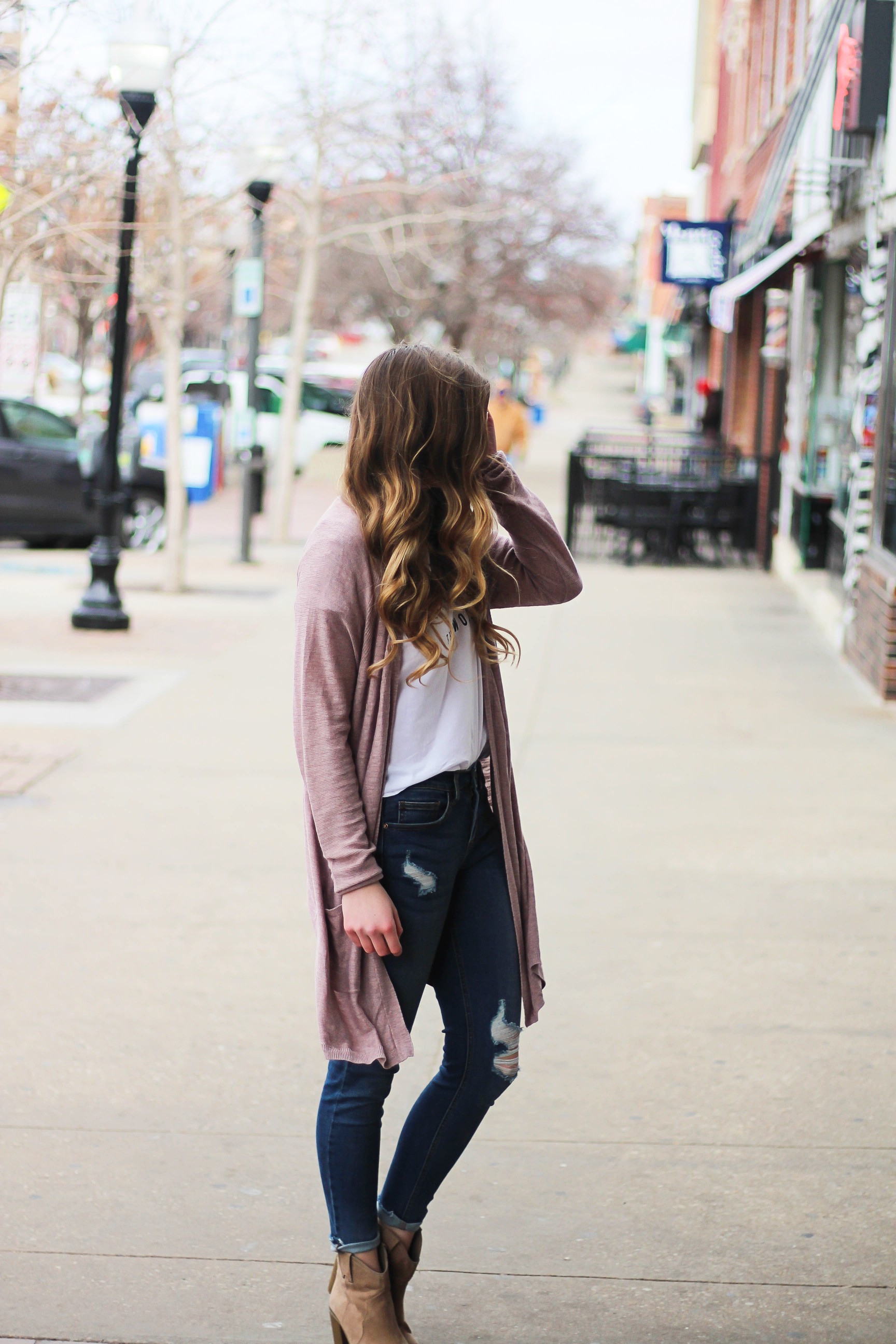 The cutest purple/pink cardigan for spring paired with my Oh Darling Let's Explore the World tee! I love this tee because it matches my wanderlust! I paired it with my favorite ripped jeans and tan suede booties. Plus of course my pink ray bans! By Lauren Lindmark on Daily Dose of Charm