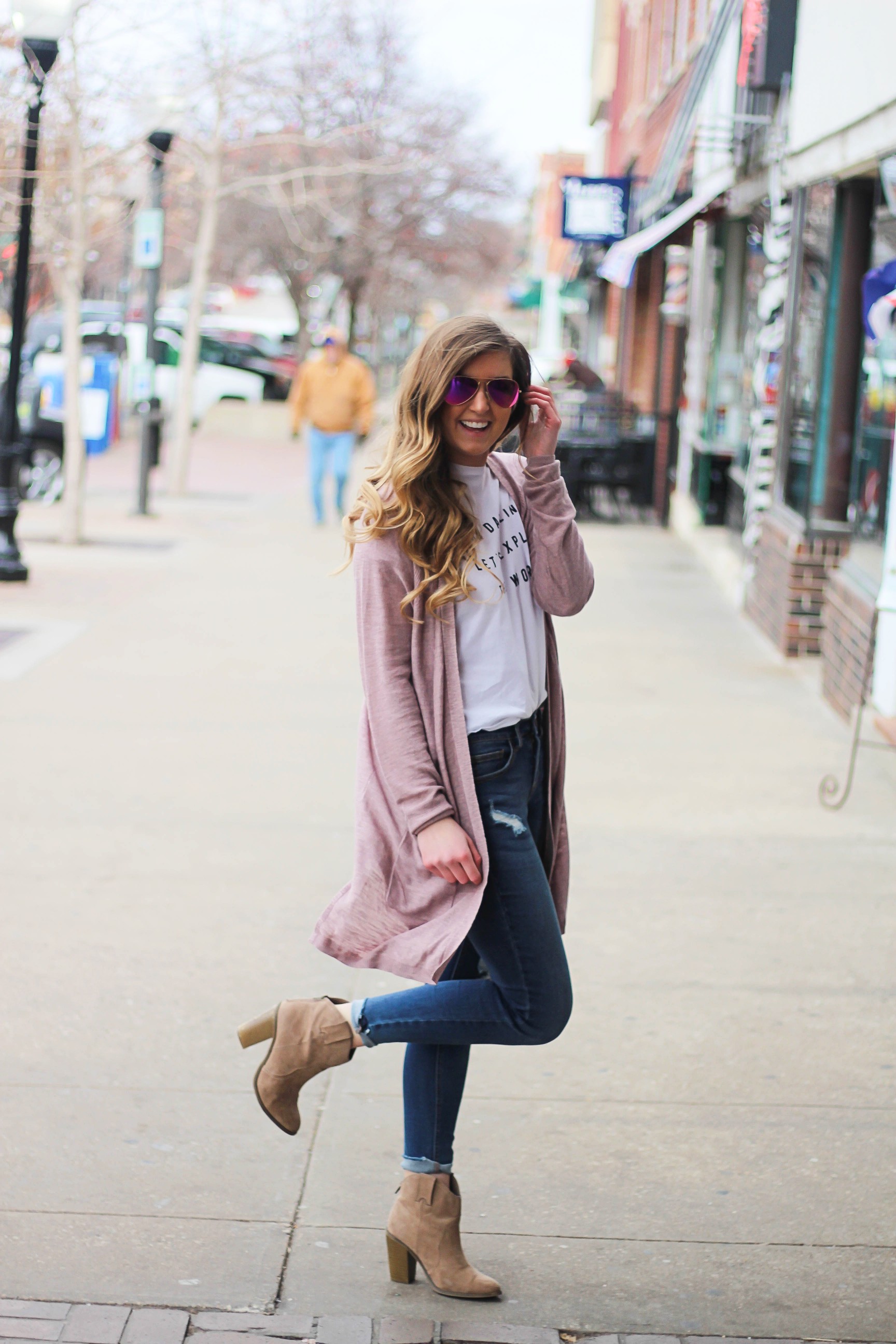 The cutest purple/pink cardigan for spring paired with my Oh Darling Let's Explore the World tee! I love this tee because it matches my wanderlust! I paired it with my favorite ripped jeans and tan suede booties. Plus of course my pink ray bans! By Lauren Lindmark on Daily Dose of Charm