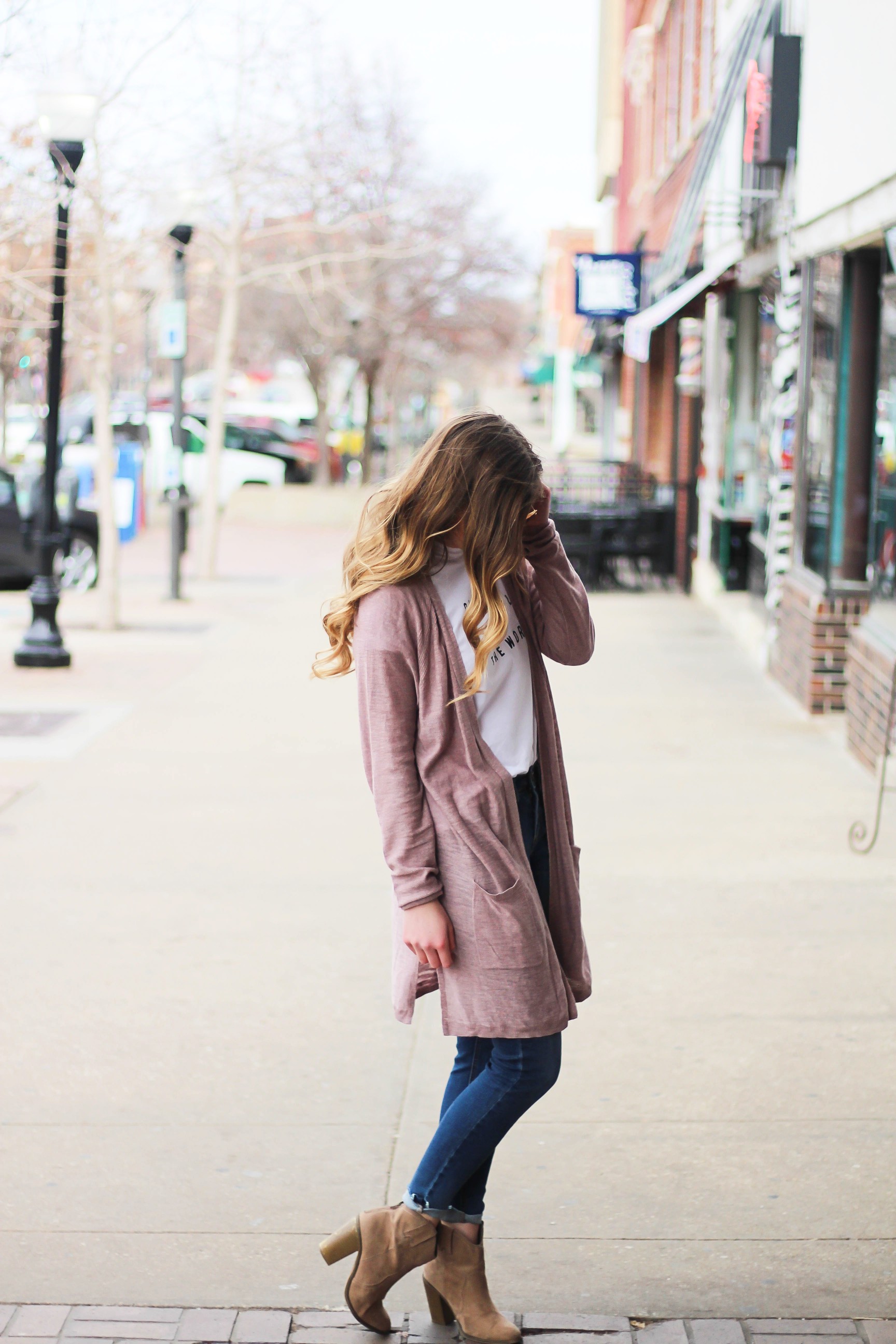 The cutest purple/pink cardigan for spring paired with my Oh Darling Let's Explore the World tee! I love this tee because it matches my wanderlust! I paired it with my favorite ripped jeans and tan suede booties. Plus of course my pink ray bans! By Lauren Lindmark on Daily Dose of Charm