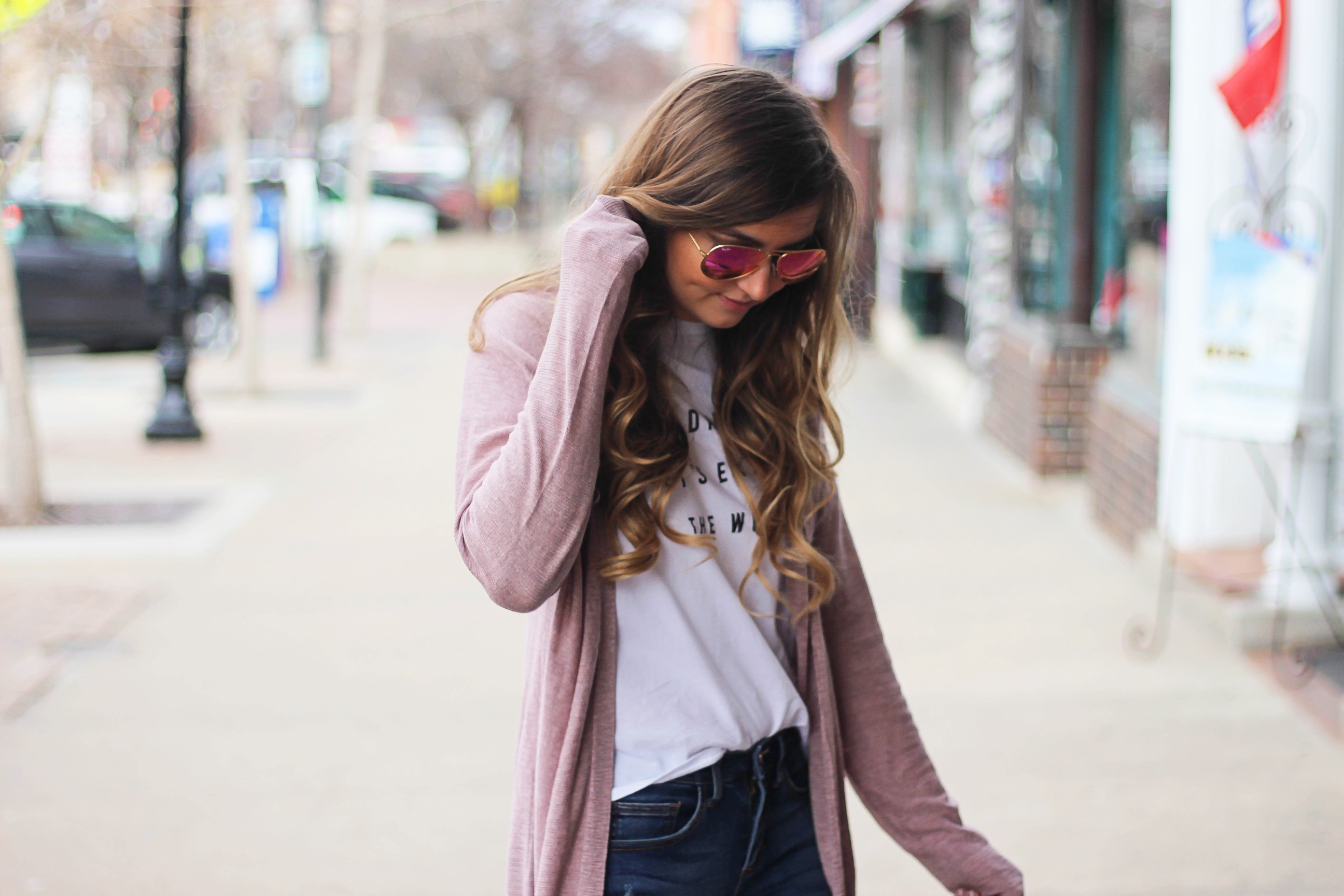 The cutest purple/pink cardigan for spring paired with my Oh Darling Let's Explore the World tee! I love this tee because it matches my wanderlust! I paired it with my favorite ripped jeans and tan suede booties. Plus of course my pink ray bans! By Lauren Lindmark on Daily Dose of Charm