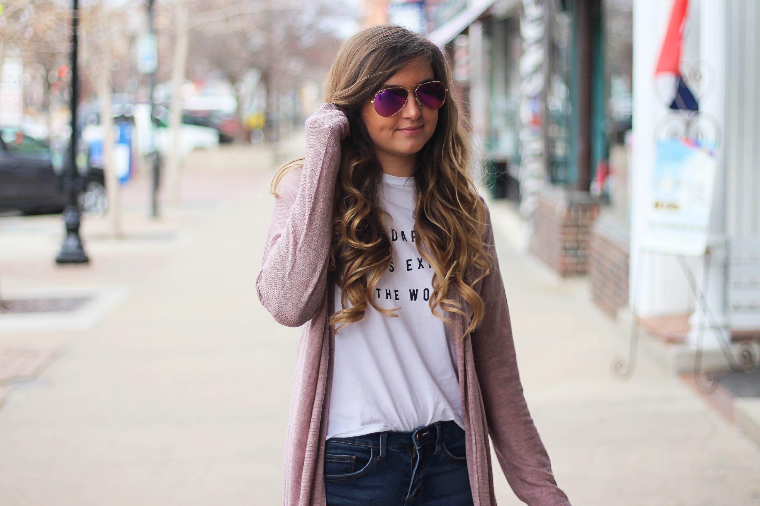 The cutest purple/pink cardigan for spring paired with my Oh Darling Let's Explore the World tee! I love this tee because it matches my wanderlust! I paired it with my favorite ripped jeans and tan suede booties. Plus of course my pink ray bans! By Lauren Lindmark on Daily Dose of Charm