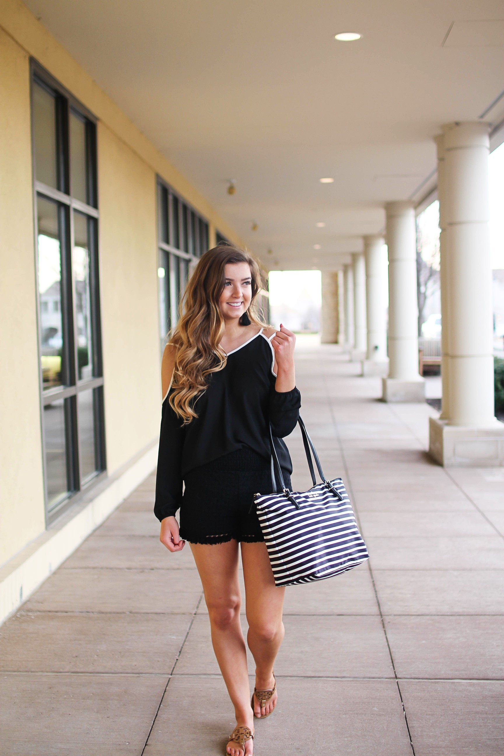 Black and white outfit! I love this black cold shoulder top with the white trim detail! I paired ti with some comfy black cotton shorts and my new black and white striped Kate spade tote! To finish off the outfit I put on my tassel earrings that are only $12! By Lauren Lindmark on Daily Dose of Charm dailydoseofcharm.com