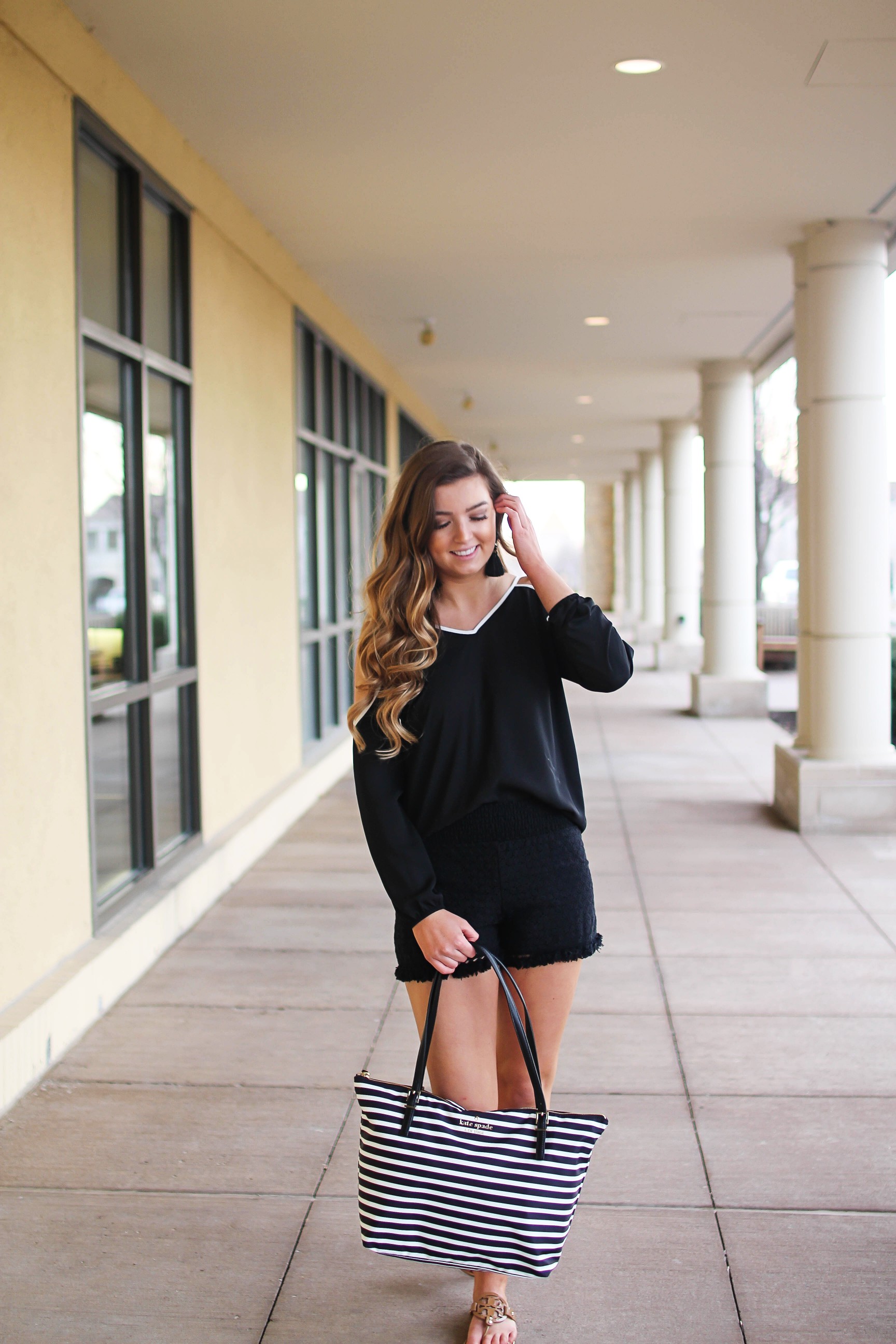 Black and white outfit! I love this black cold shoulder top with the white trim detail! I paired ti with some comfy black cotton shorts and my new black and white striped Kate spade tote! To finish off the outfit I put on my tassel earrings that are only $12! By Lauren Lindmark on Daily Dose of Charm dailydoseofcharm.com