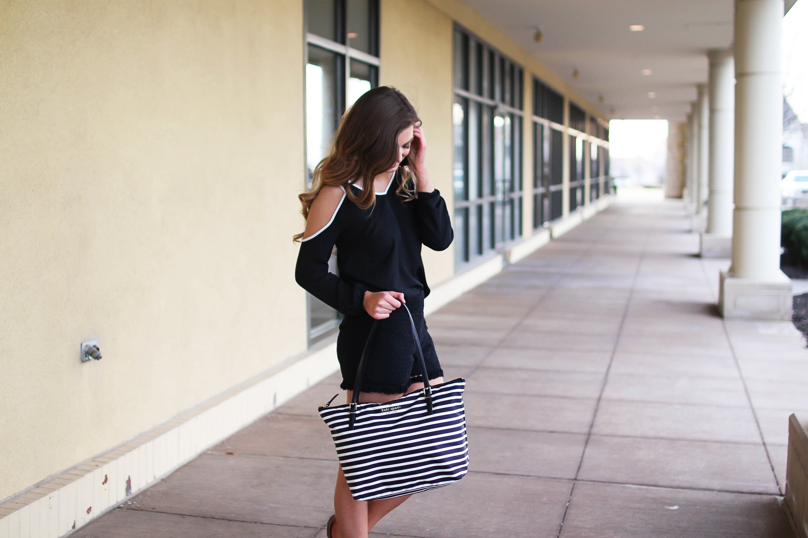 Black and white outfit! I love this black cold shoulder top with the white trim detail! I paired ti with some comfy black cotton shorts and my new black and white striped Kate spade tote! To finish off the outfit I put on my tassel earrings that are only $12! By Lauren Lindmark on Daily Dose of Charm dailydoseofcharm.com