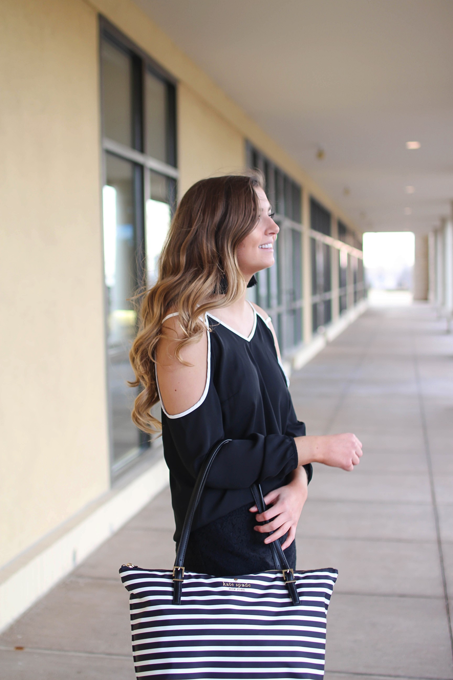 Black and white outfit! I love this black cold shoulder top with the white trim detail! I paired ti with some comfy black cotton shorts and my new black and white striped Kate spade tote! To finish off the outfit I put on my tassel earrings that are only $12! By Lauren Lindmark on Daily Dose of Charm dailydoseofcharm.com