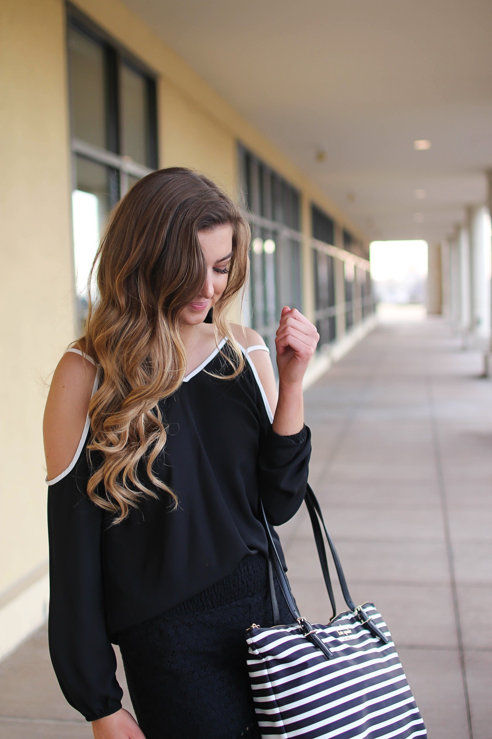 Black and white outfit! I love this black cold shoulder top with the white trim detail! I paired ti with some comfy black cotton shorts and my new black and white striped Kate spade tote! To finish off the outfit I put on my tassel earrings that are only $12! By Lauren Lindmark on Daily Dose of Charm dailydoseofcharm.com