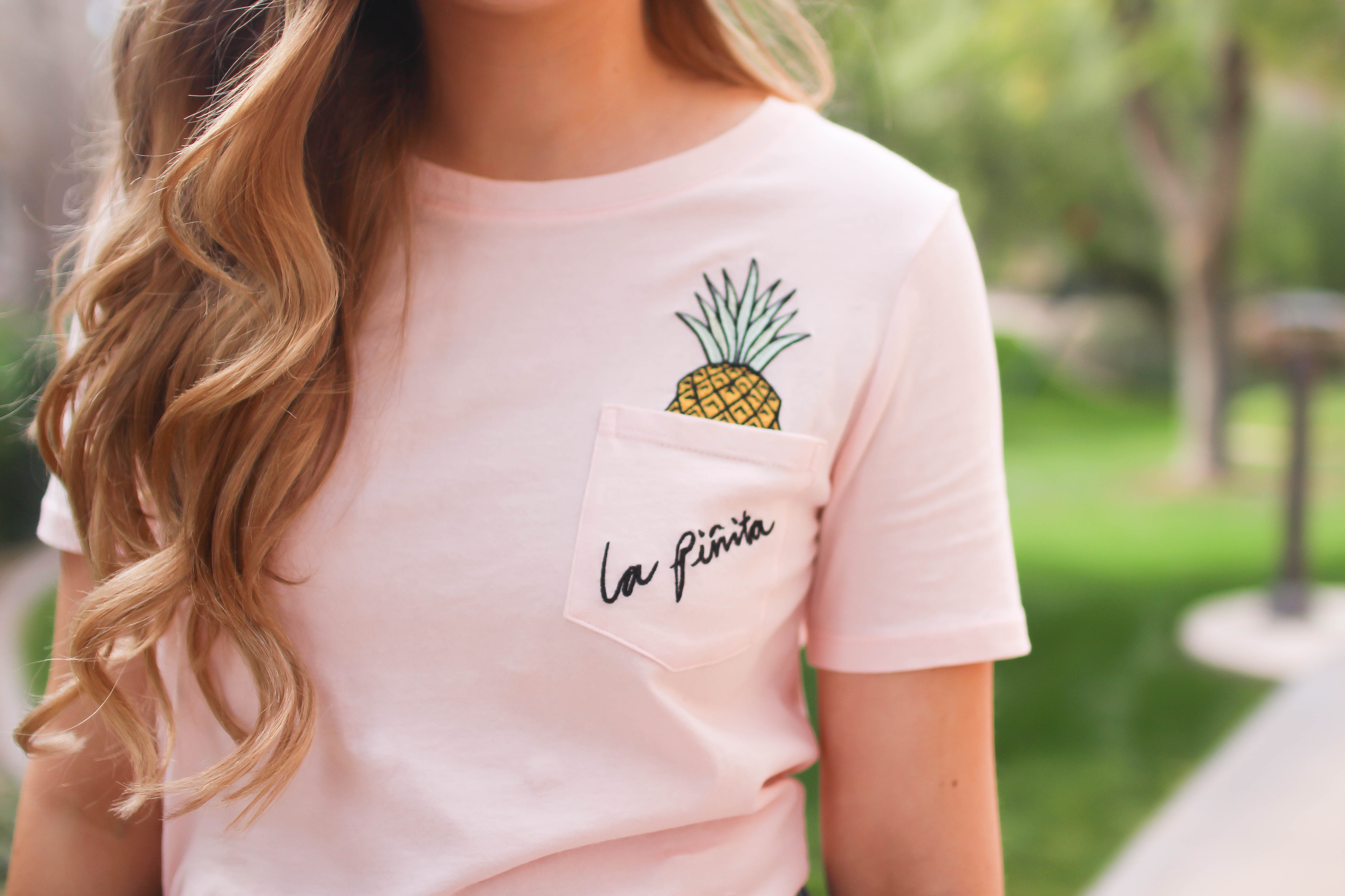 The cutest pink pineapple tee perfect for spring break and summer look! Perfect outfit idea for spring and summer! Paired with jean shorts and Gold New Balance shoes. By Lauren Lindmark on Daily Dose of Charm dailydoseofcharm.com