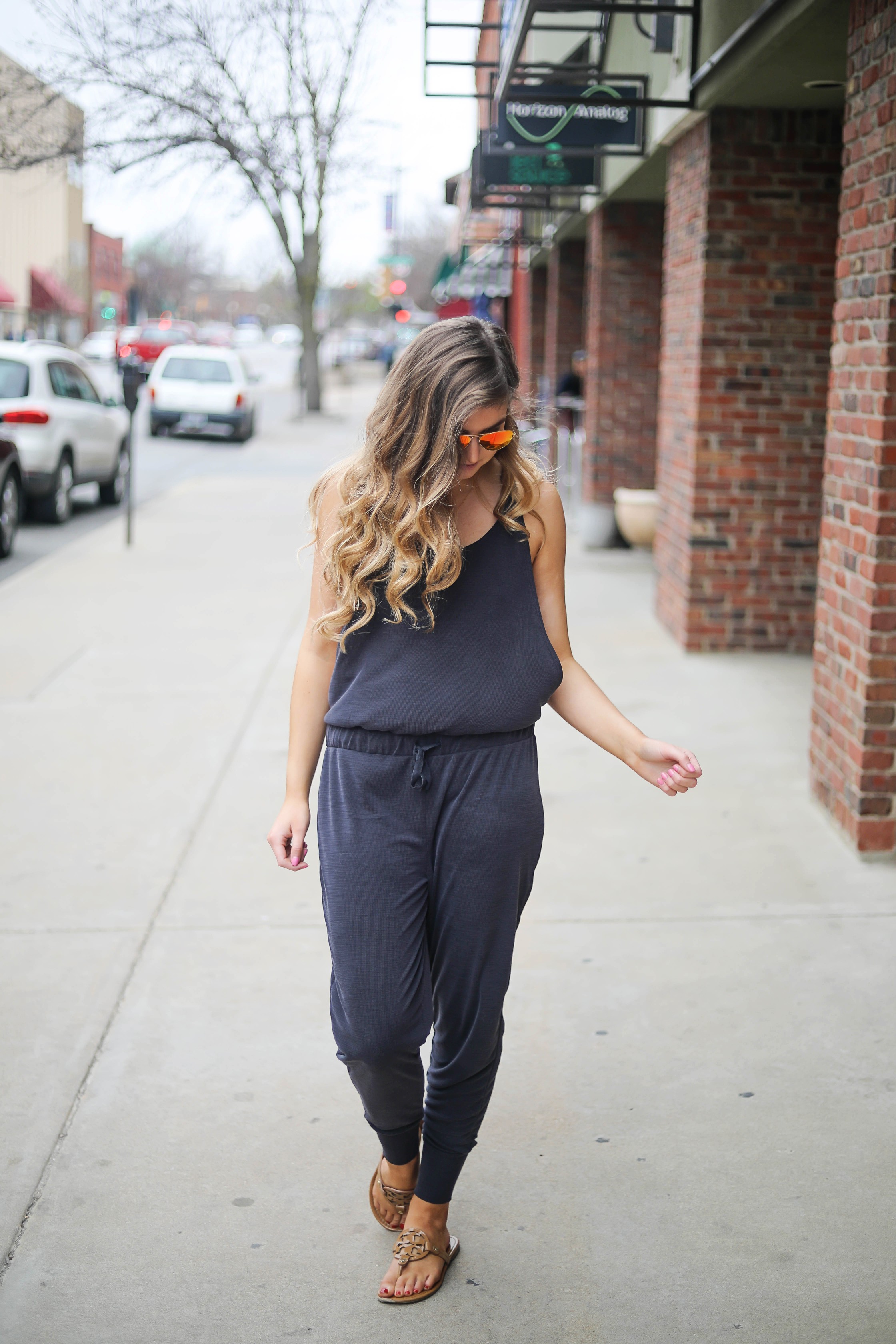 The cutest jumpsuit that is open on the sides and slouchy! I love comfy jumpsuits and this one is my favorite! Paired with red mirrored ray ban aviators and tory burch miller sandals! By Lauren Lindmark dailydoseofcharm.com daily dose of charm