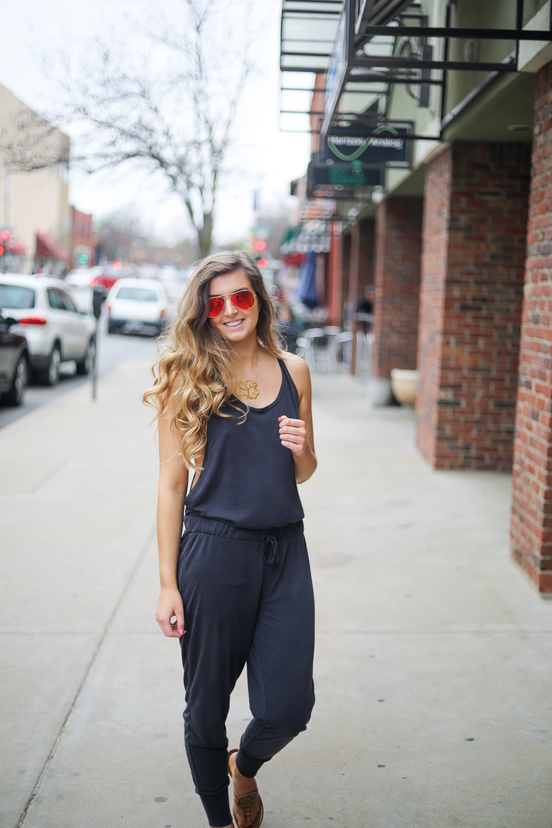 The cutest jumpsuit that is open on the sides and slouchy! I love comfy jumpsuits and this one is my favorite! Paired with red mirrored ray ban aviators and tory burch miller sandals! By Lauren Lindmark dailydoseofcharm.com daily dose of charm
