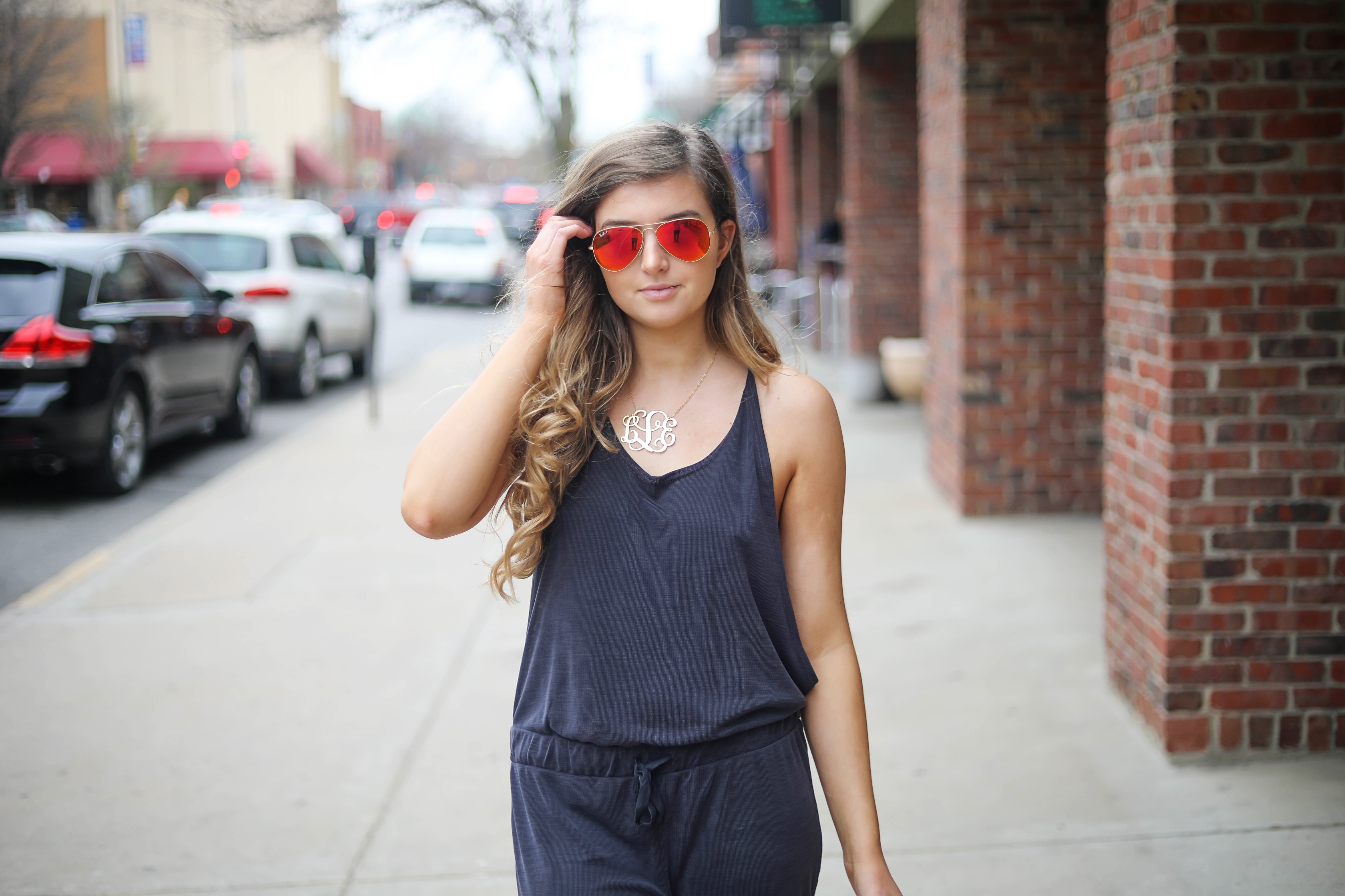 The cutest jumpsuit that is open on the sides and slouchy! I love comfy jumpsuits and this one is my favorite! Paired with red mirrored ray ban aviators and tory burch miller sandals! By Lauren Lindmark dailydoseofcharm.com daily dose of charm