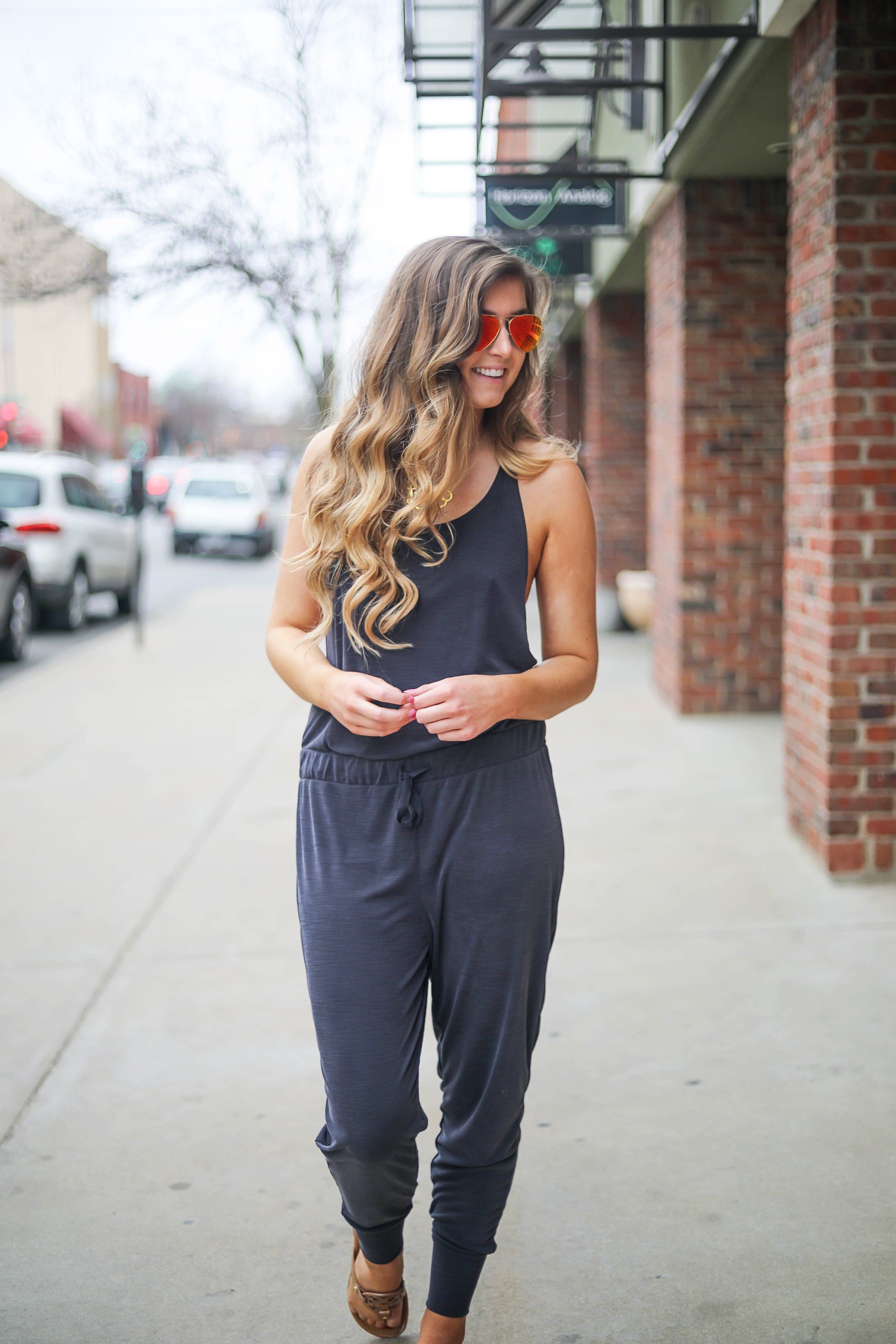 The cutest jumpsuit that is open on the sides and slouchy! I love comfy jumpsuits and this one is my favorite! Paired with red mirrored ray ban aviators and tory burch miller sandals! By Lauren Lindmark dailydoseofcharm.com daily dose of charm