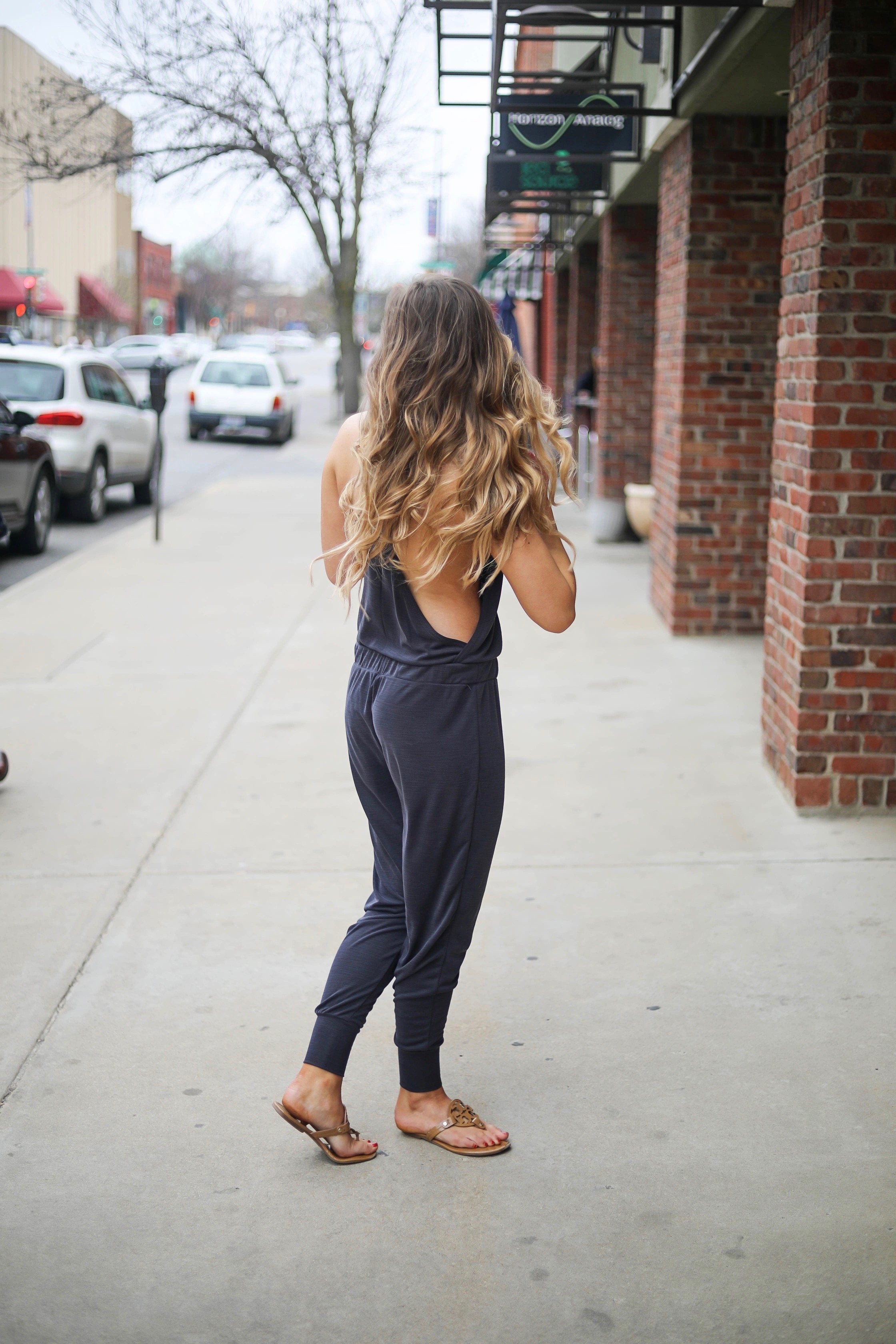 The cutest jumpsuit that is open on the sides and slouchy! I love comfy jumpsuits and this one is my favorite! Paired with red mirrored ray ban aviators and tory burch miller sandals! By Lauren Lindmark dailydoseofcharm.com daily dose of charm