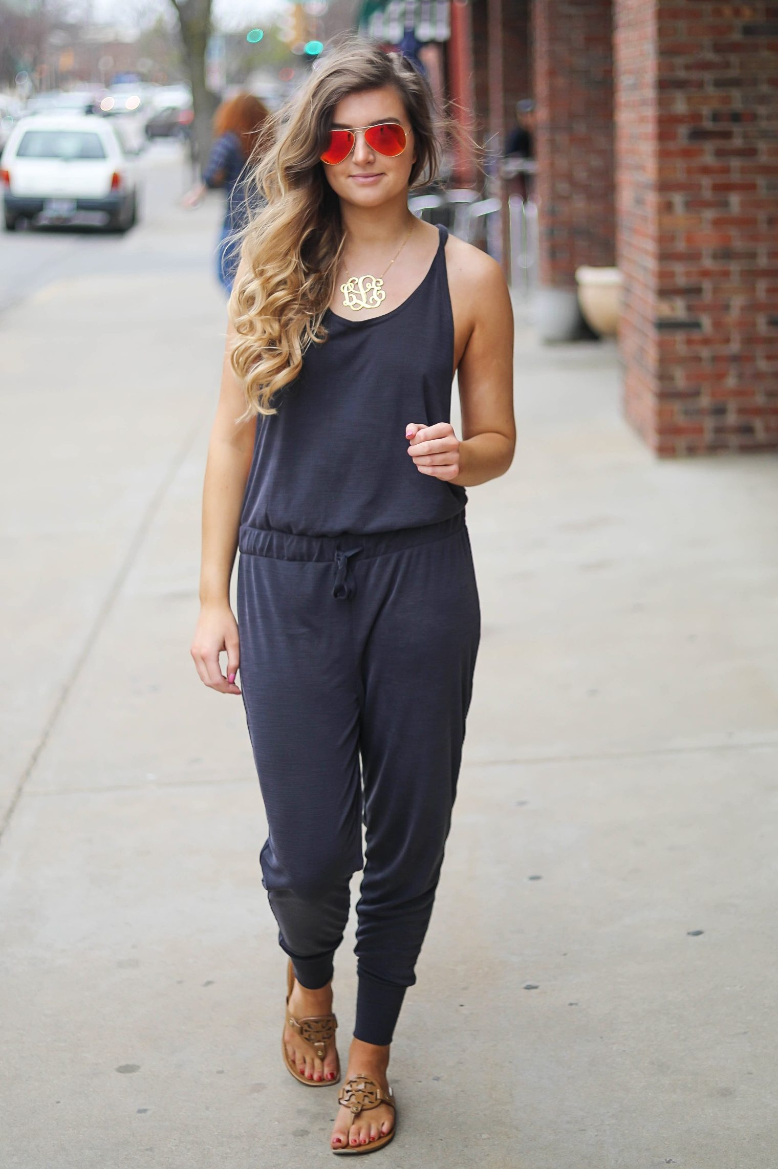 The cutest jumpsuit that is open on the sides and slouchy! I love comfy jumpsuits and this one is my favorite! Paired with red mirrored ray ban aviators and tory burch miller sandals! By Lauren Lindmark dailydoseofcharm.com daily dose of charm