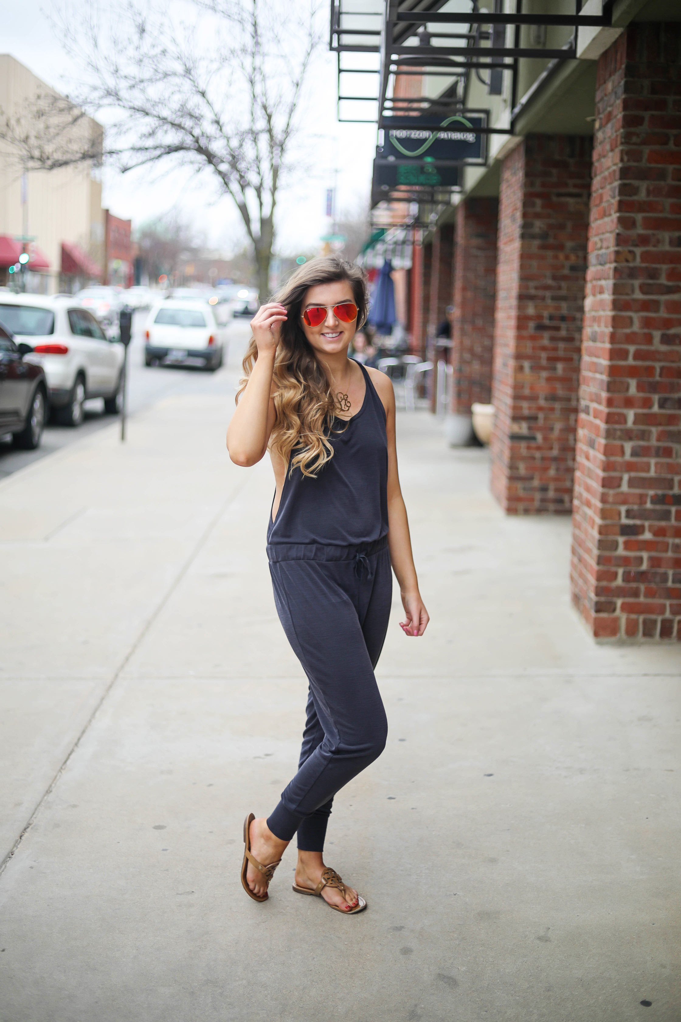 The cutest jumpsuit that is open on the sides and slouchy! I love comfy jumpsuits and this one is my favorite! Paired with red mirrored ray ban aviators and tory burch miller sandals! By Lauren Lindmark dailydoseofcharm.com daily dose of charm