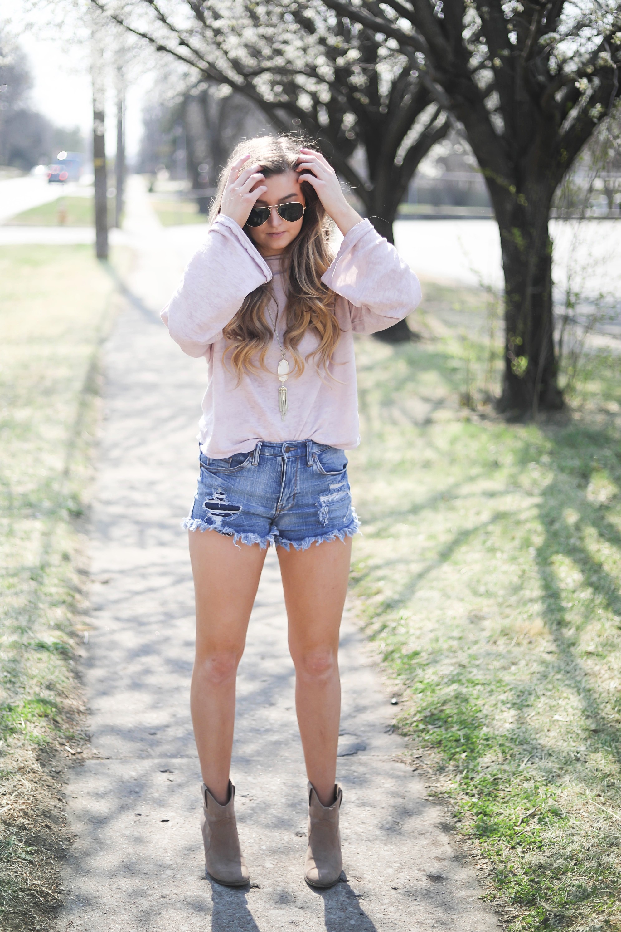 Spring outfit! You can tell it's officially spring when the trees start to bloom! I love this cozy pink top with ripped jeans. I paired them with my favorite booties and white kendra Scott necklace! By Lauren Lindmark dailydoseofcharm.com daily dose of charm